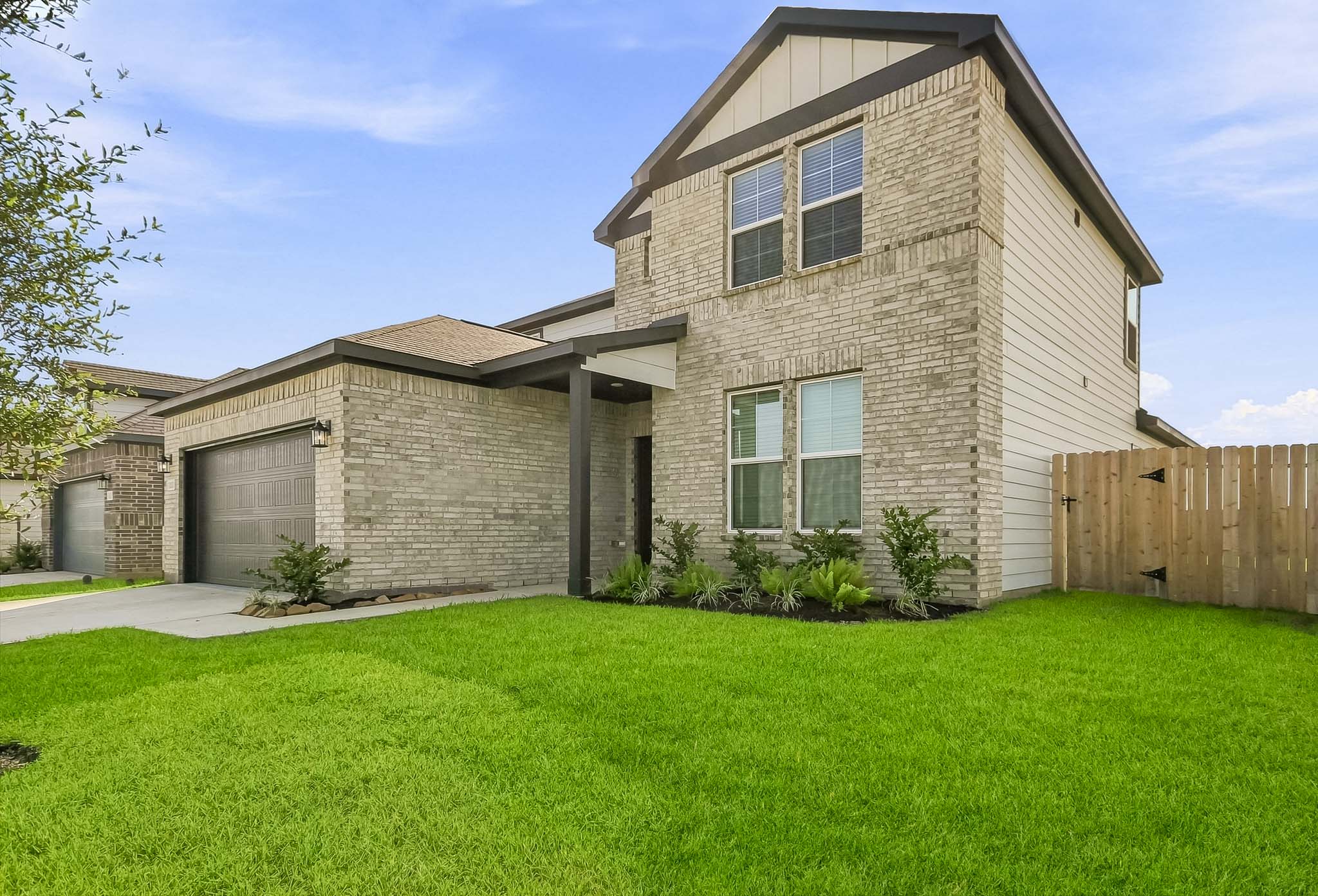 A house with a fence and grass.