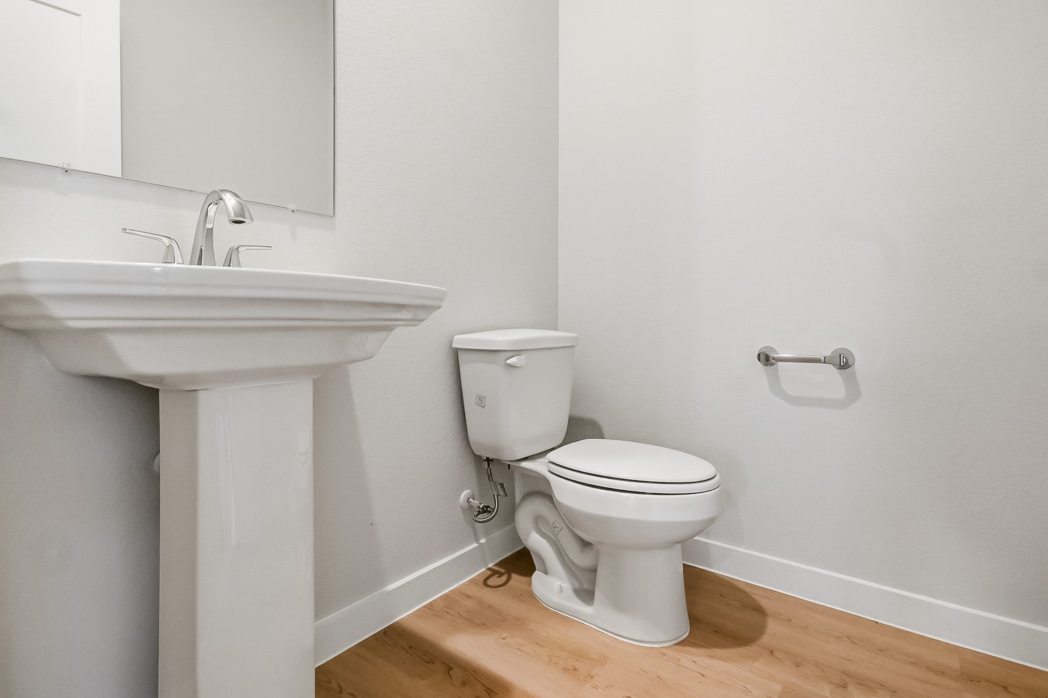 A toilet and sink in a bathroom.