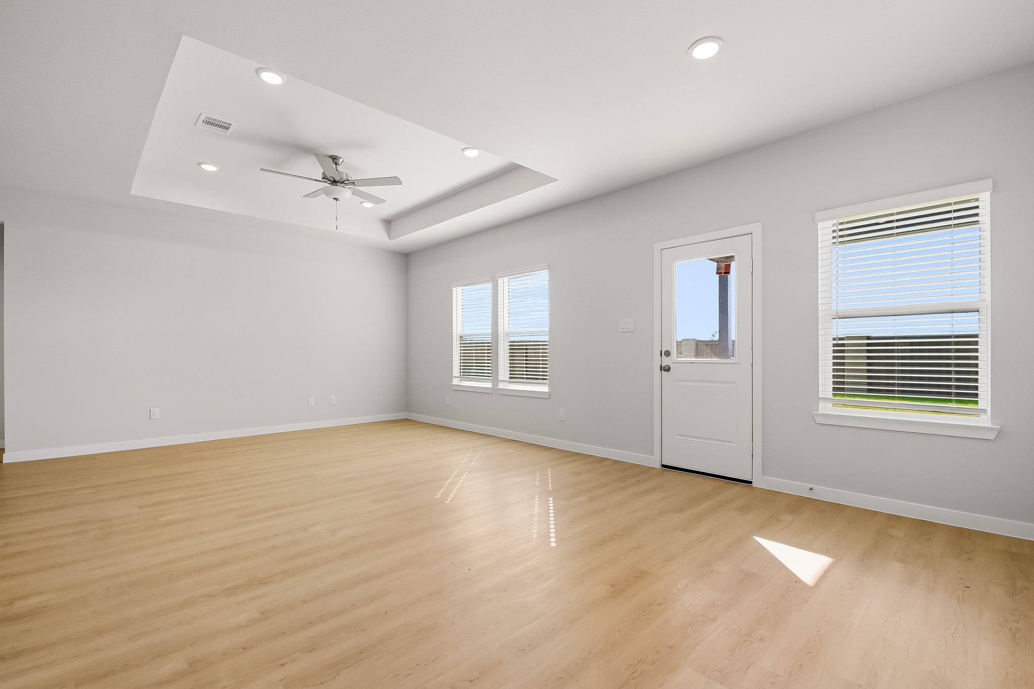 A room with a wood floor and white walls.