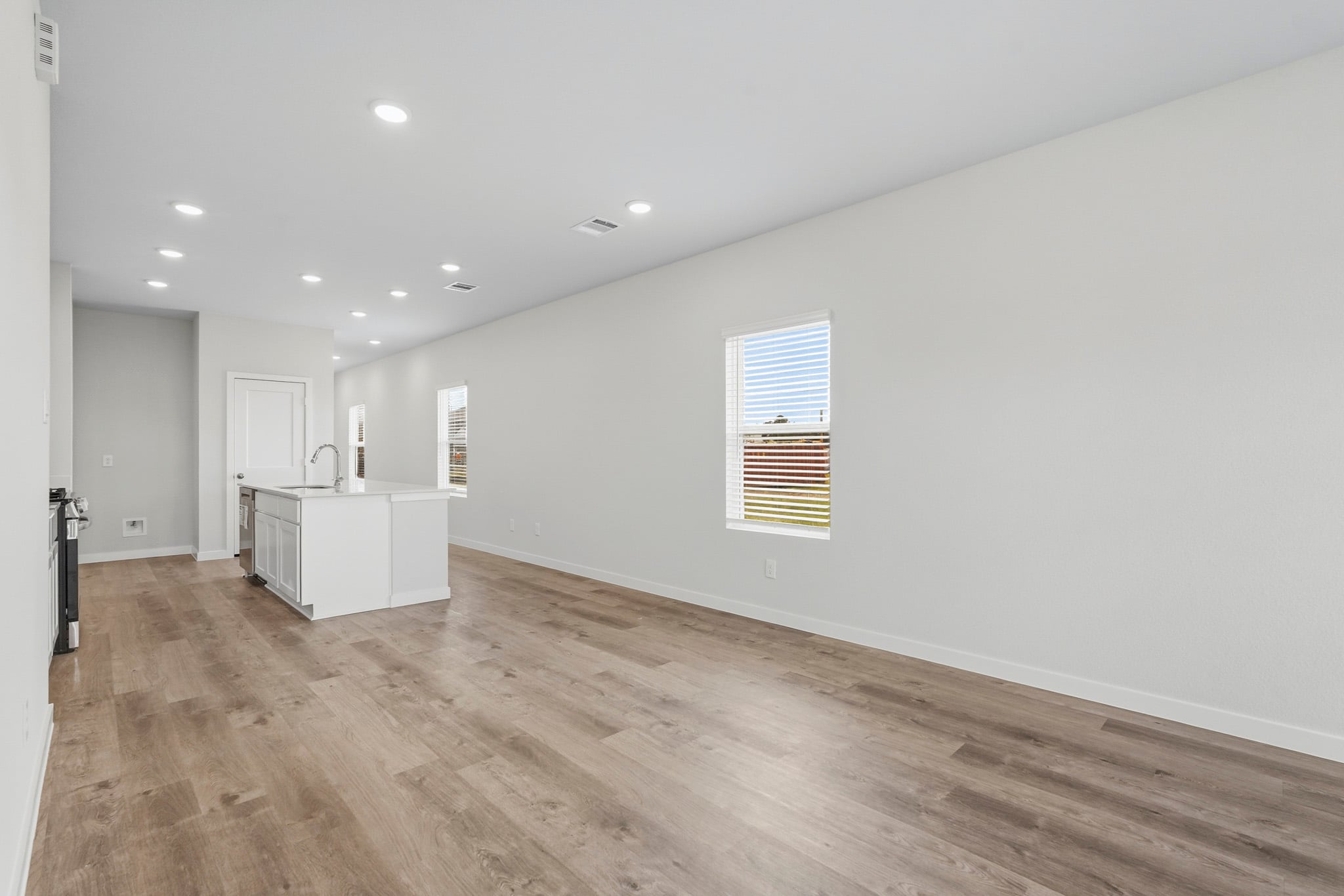 A room with white walls and a wood floor.