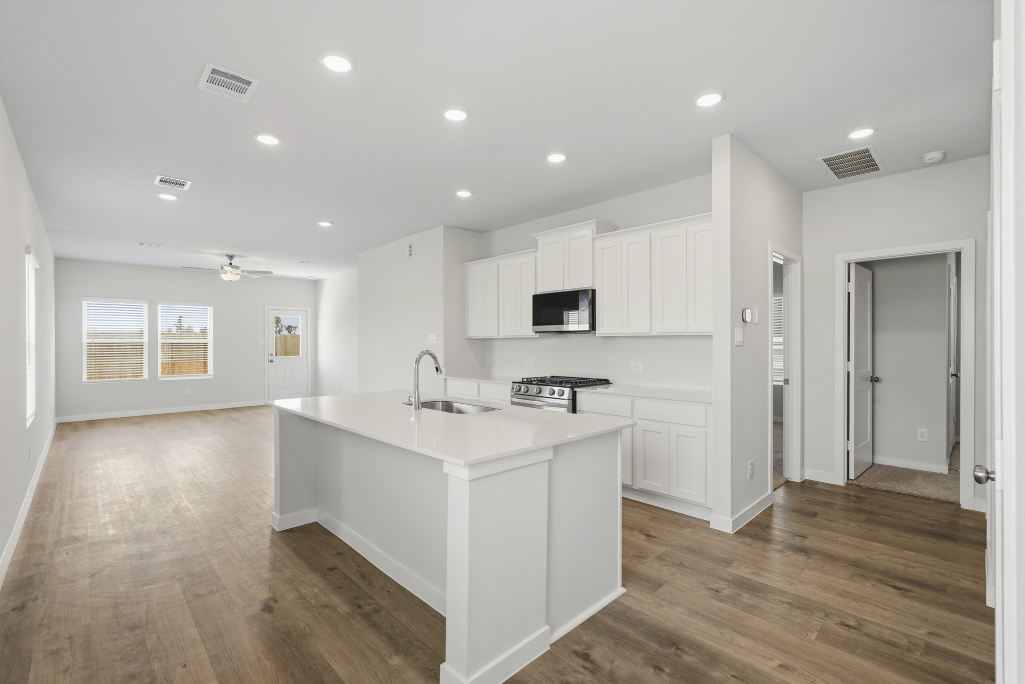 A kitchen with white cabinets.
