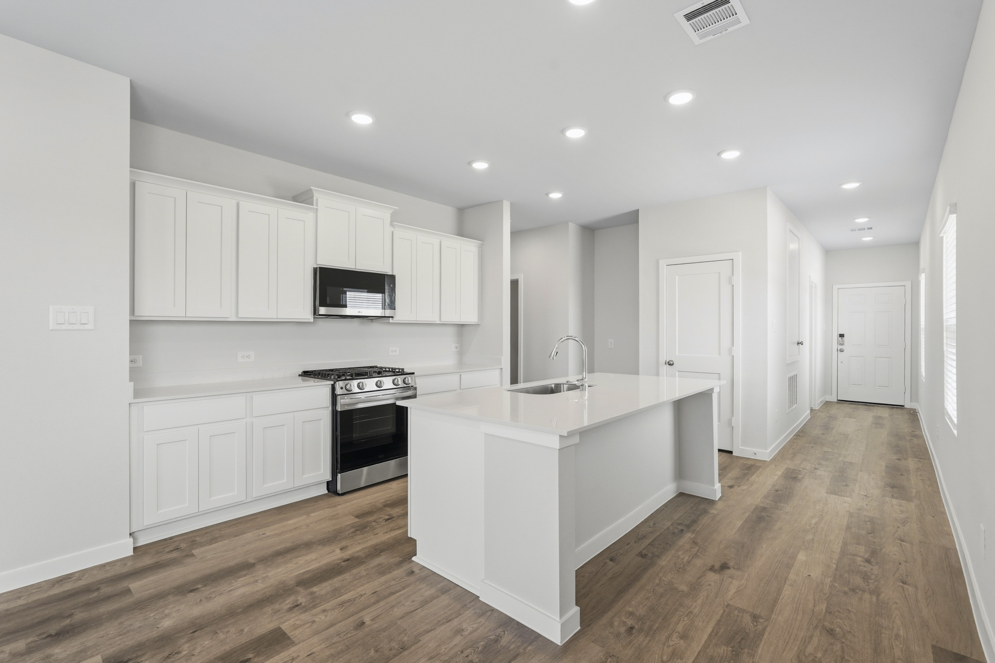 A kitchen with white cabinets.