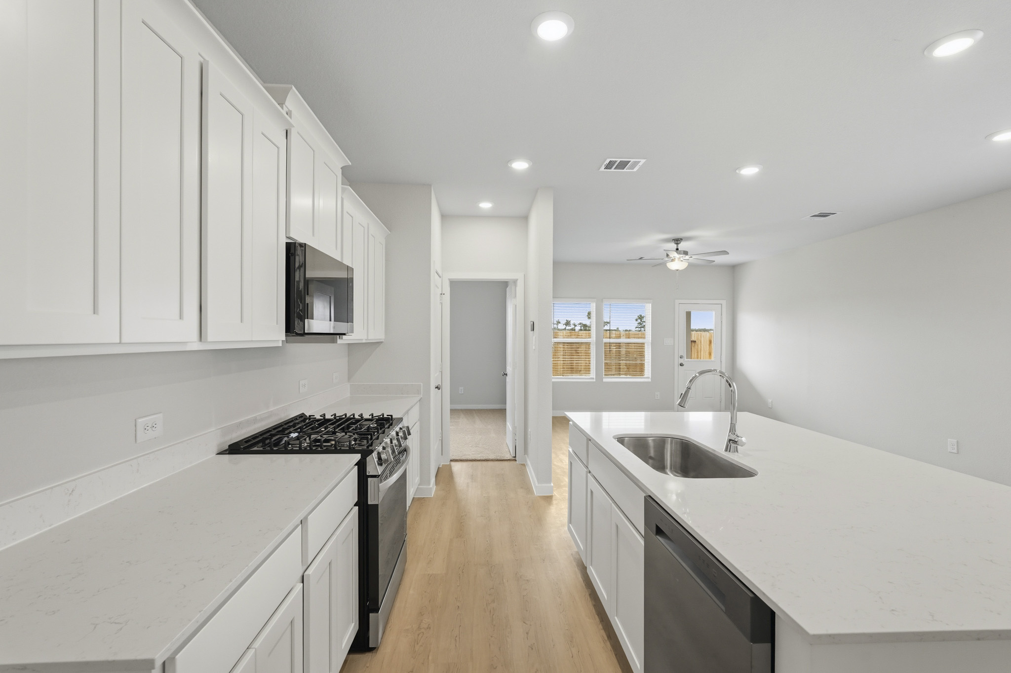 A kitchen with white cabinets.