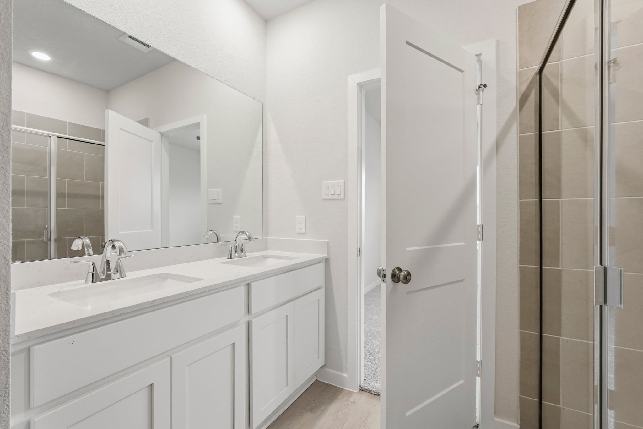 A bathroom with a sink and shower.