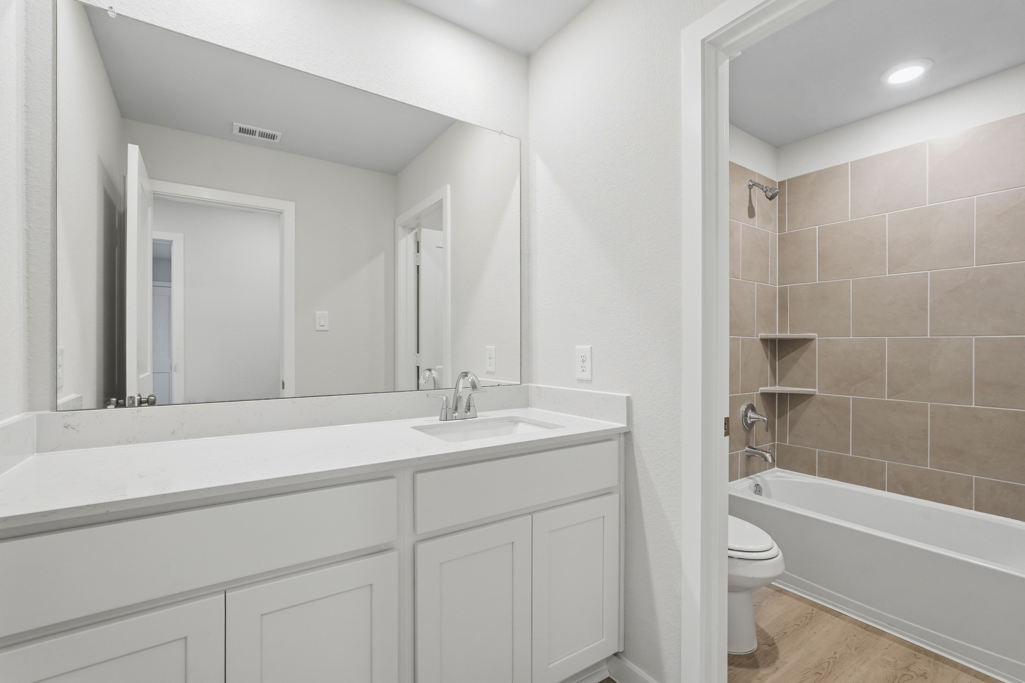 A bathroom with a tub sink and toilet.