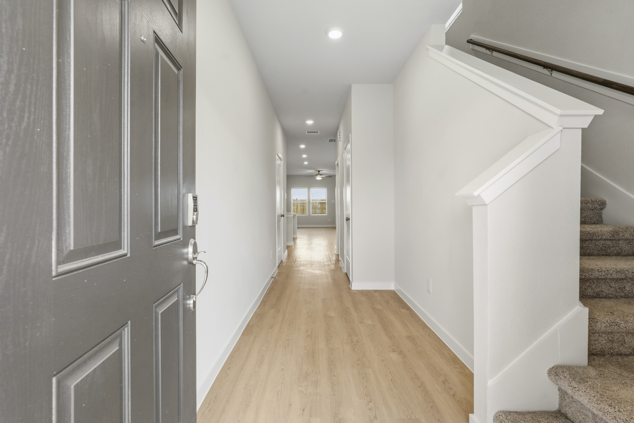 A hallway with white walls.