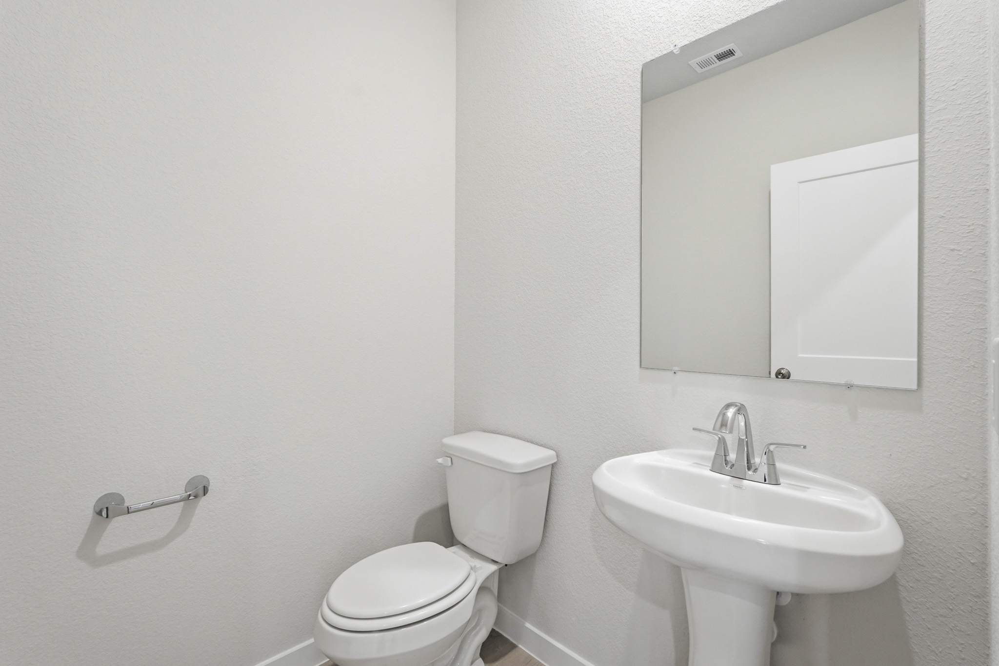 A bathroom with a toilet and sink.