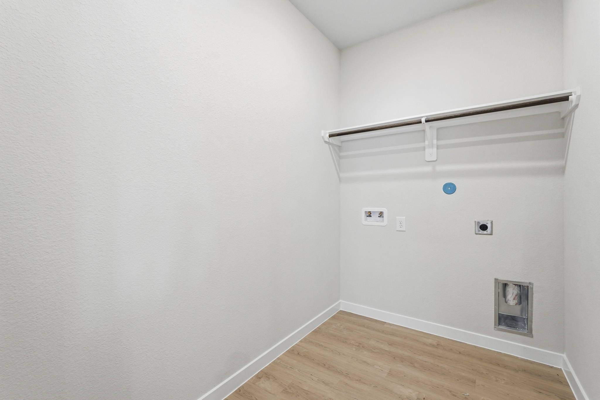 A white wall with a picture frame.