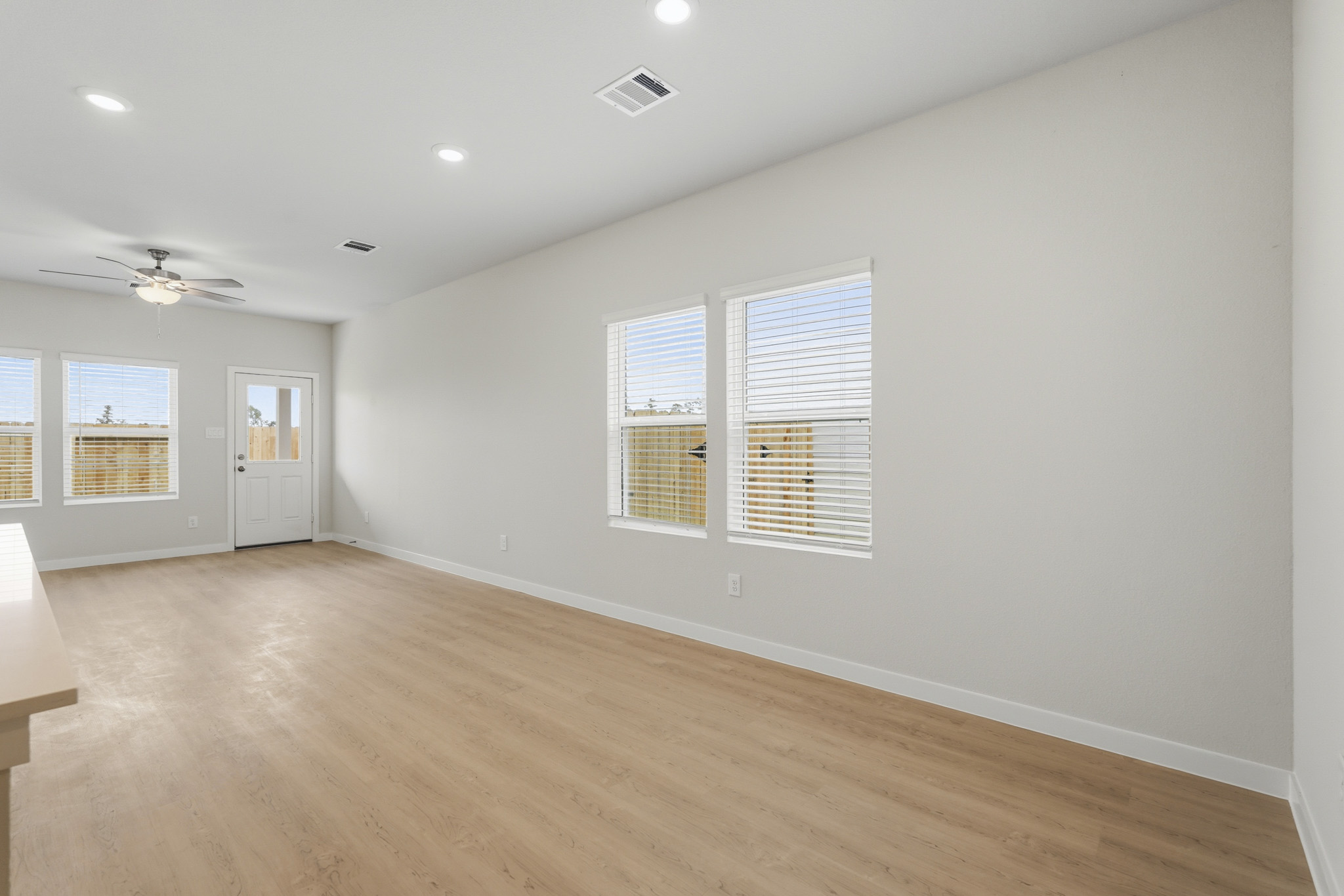 A room with a wood floor and white walls.