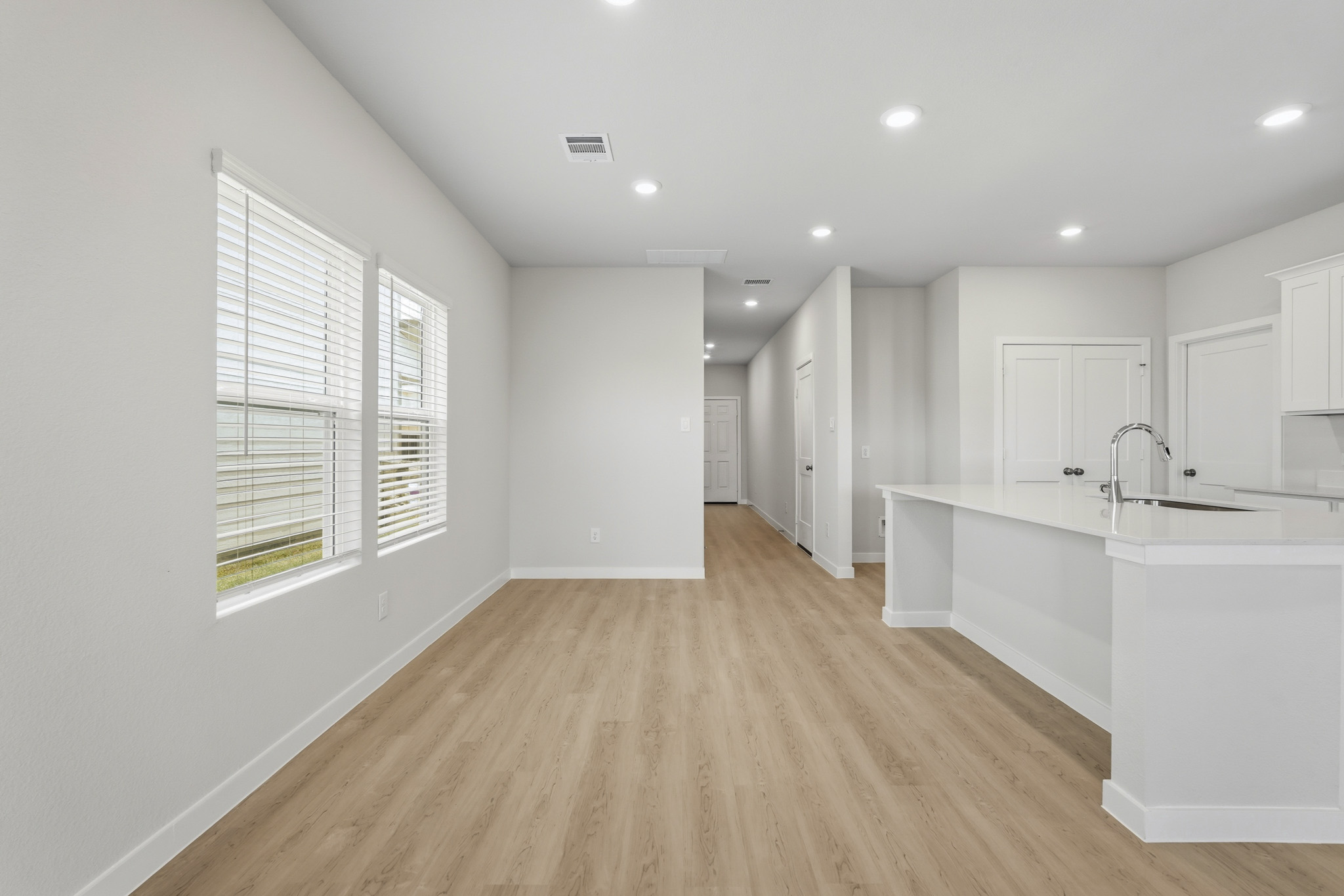 A kitchen with white cabinets.