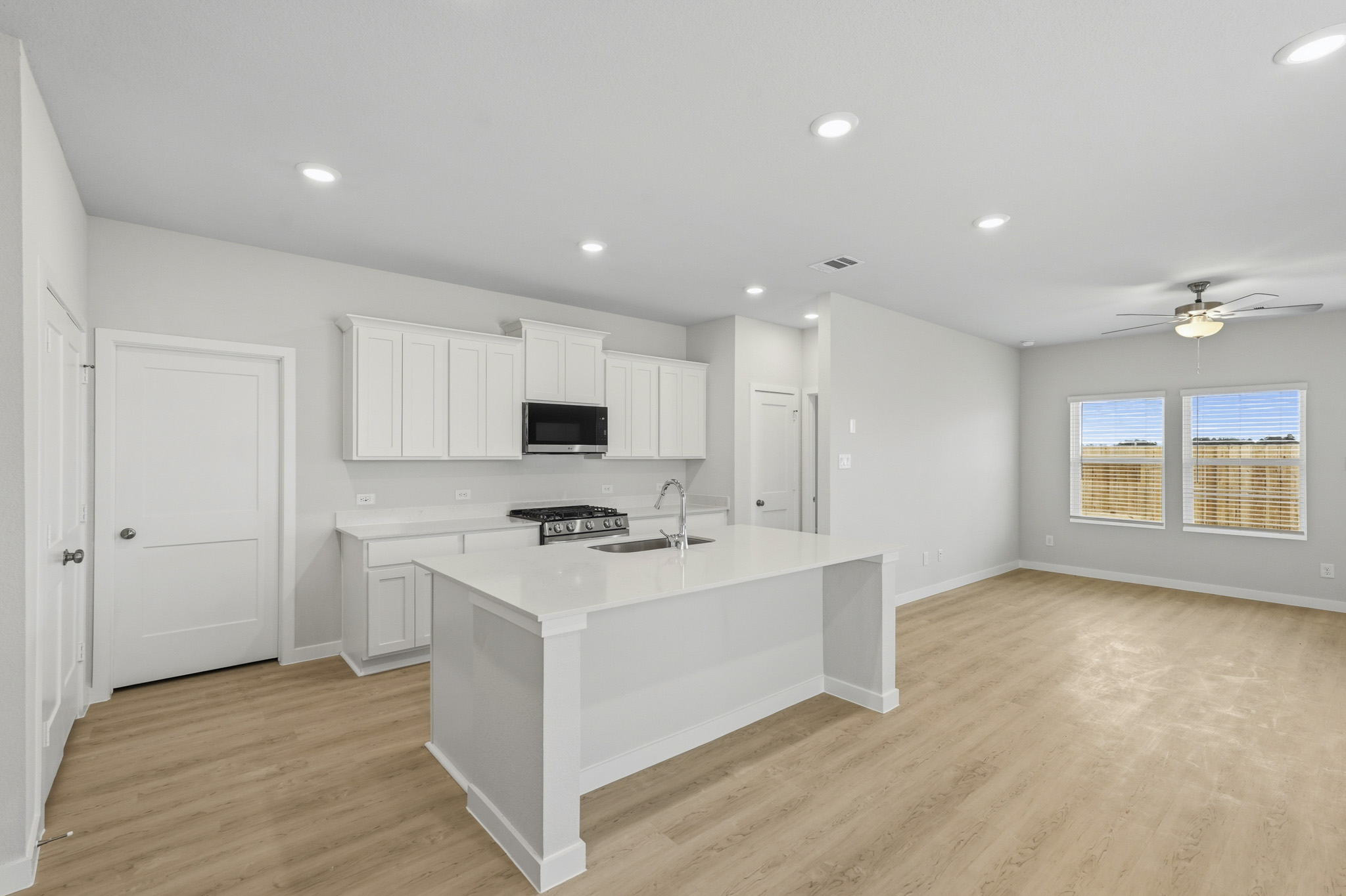 A kitchen with white cabinets.
