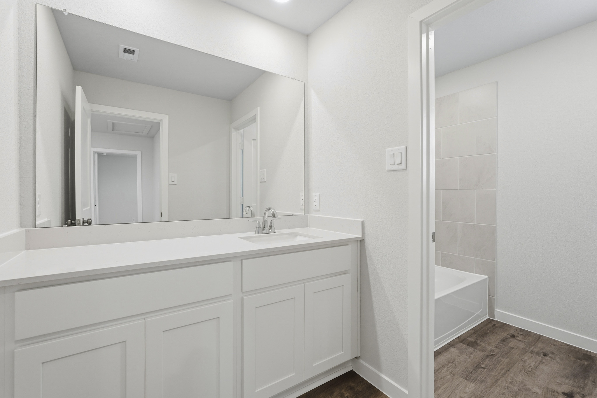 A bathroom with a sink and a bathtub.