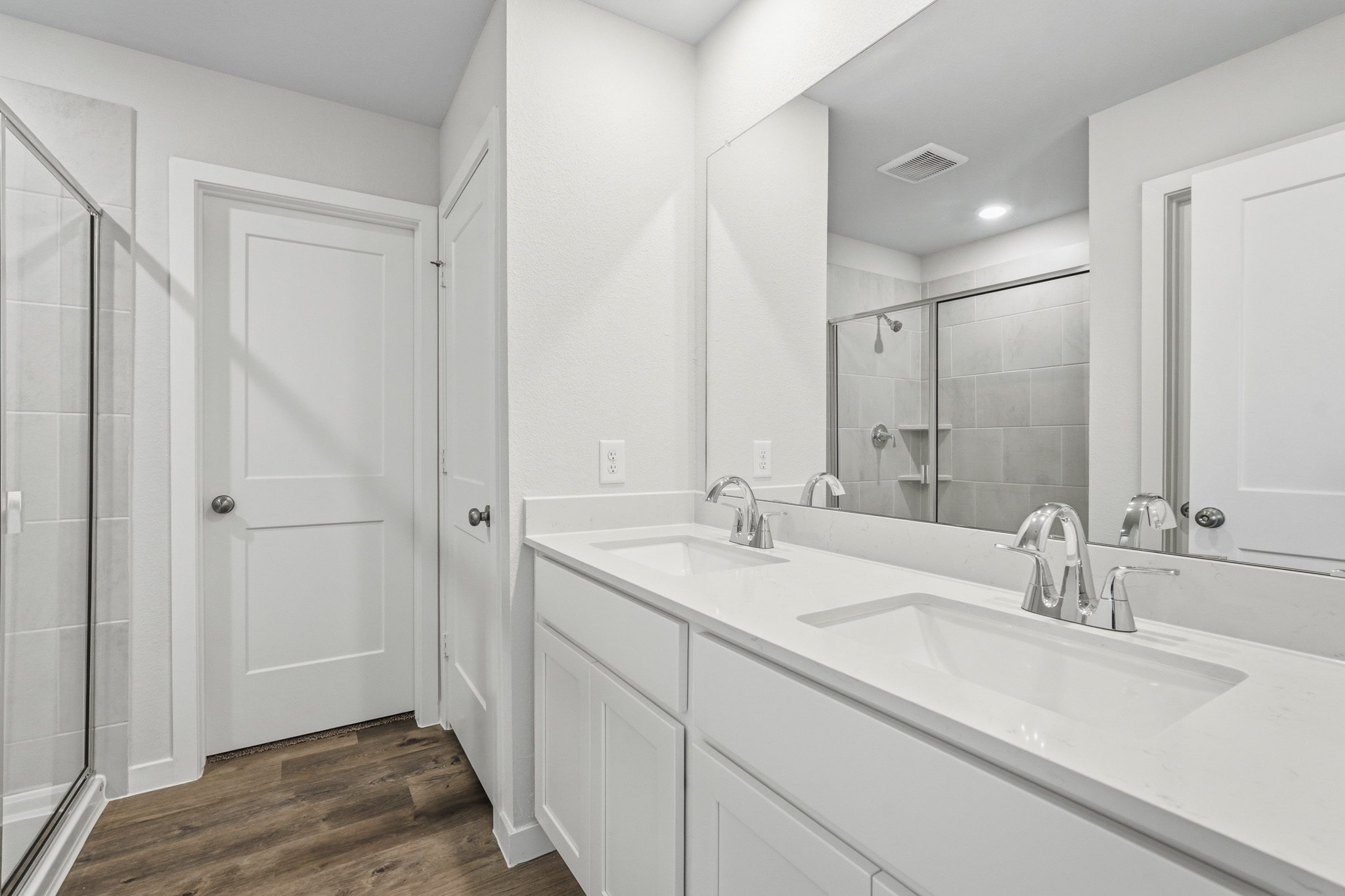 A bathroom with a large mirror.