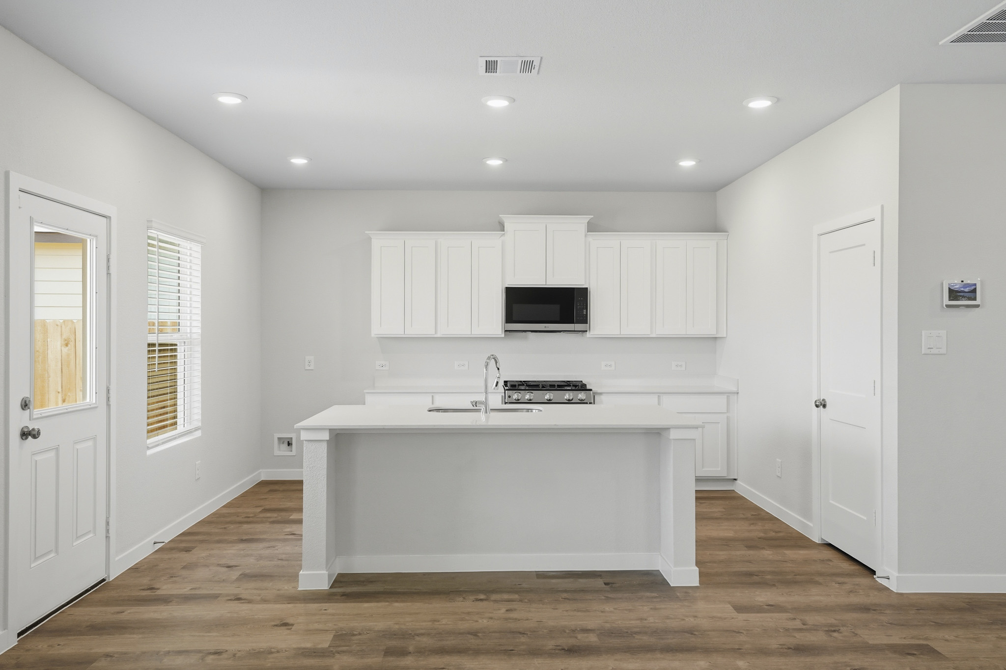 A kitchen with white cabinets.