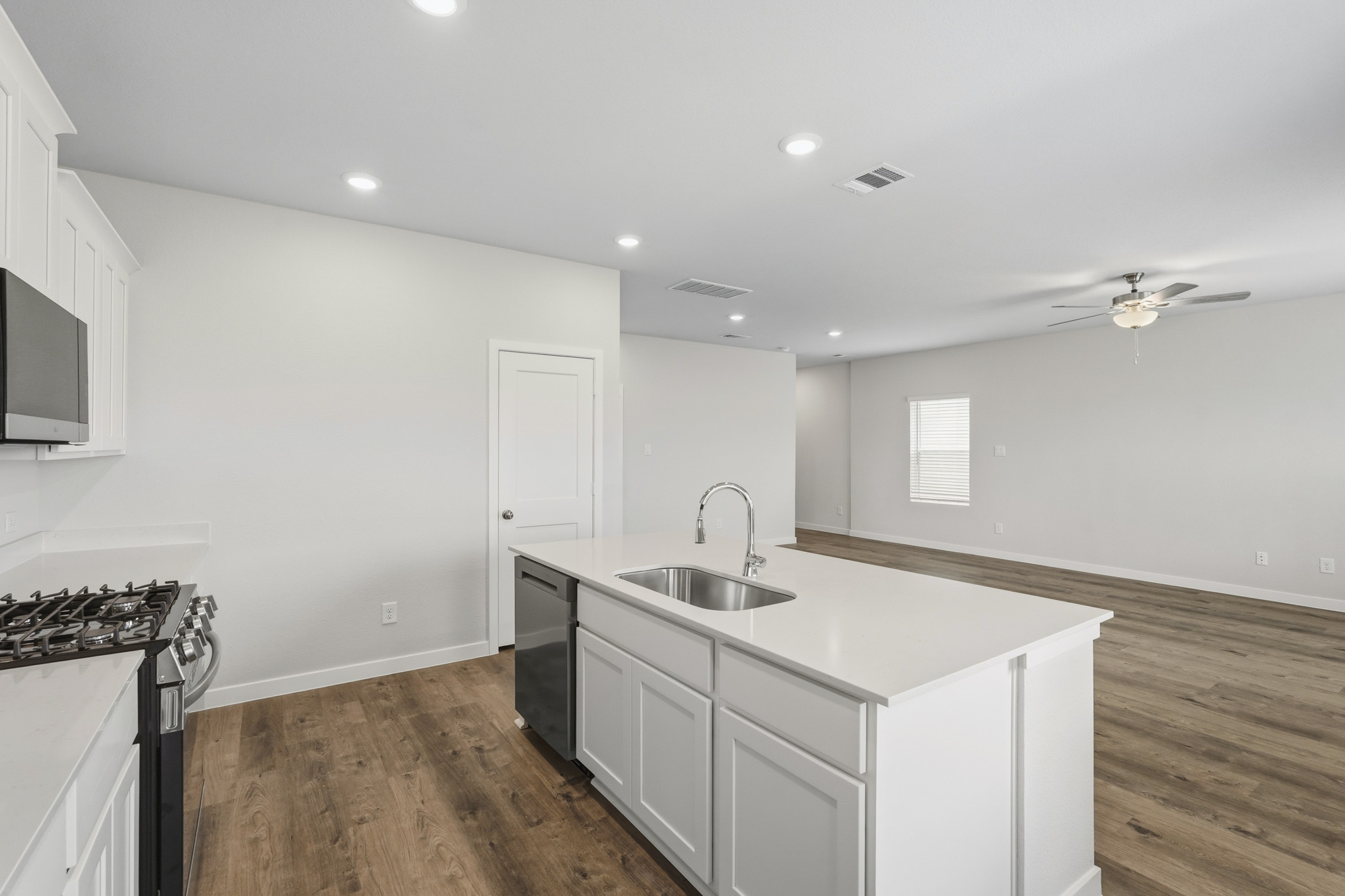A kitchen with white cabinets.
