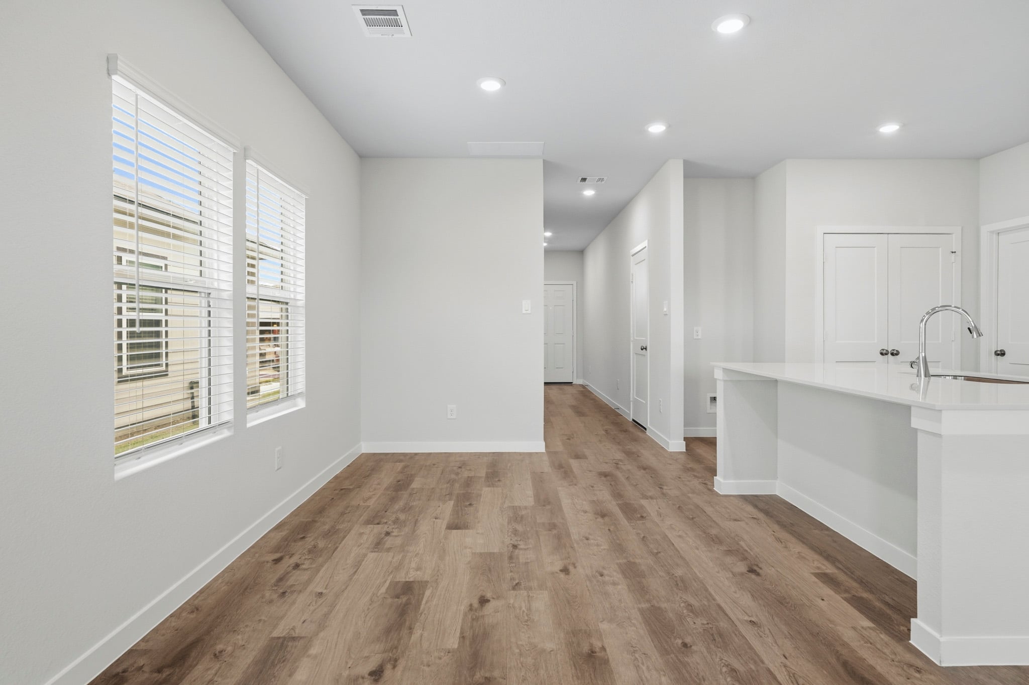 A kitchen with white cabinets.