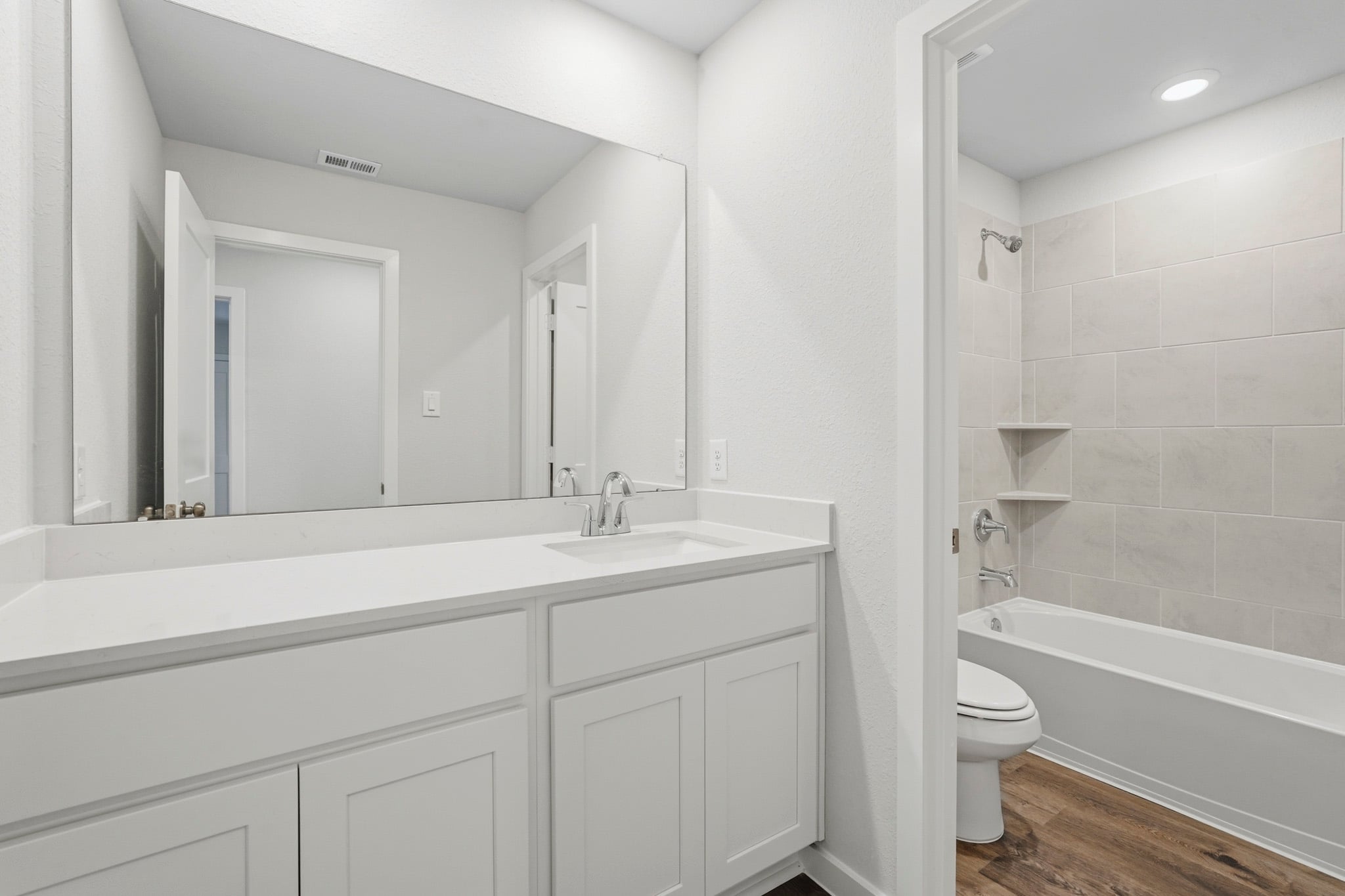 A bathroom with a tub sink and toilet.