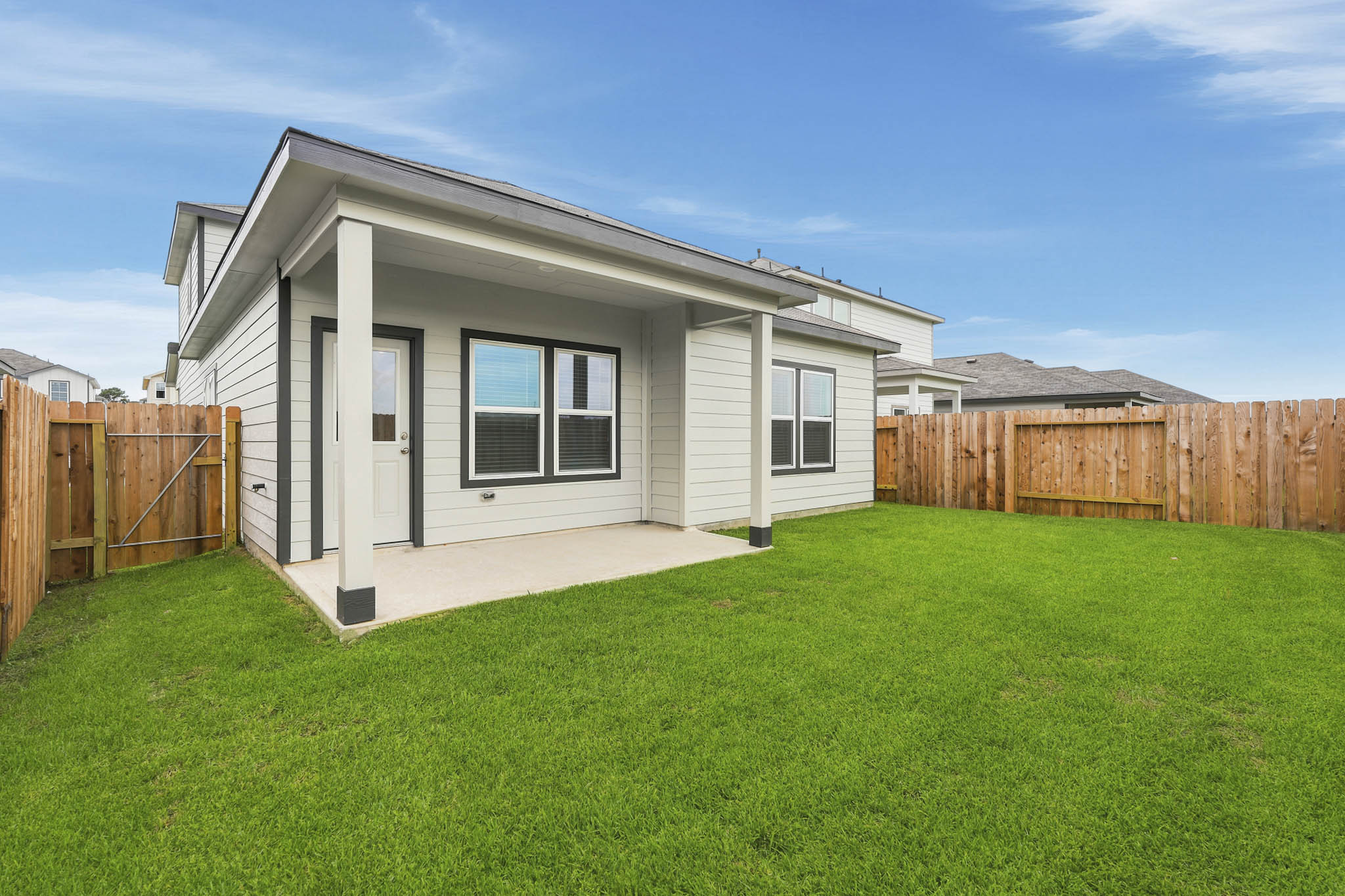 A house with a fence and grass.