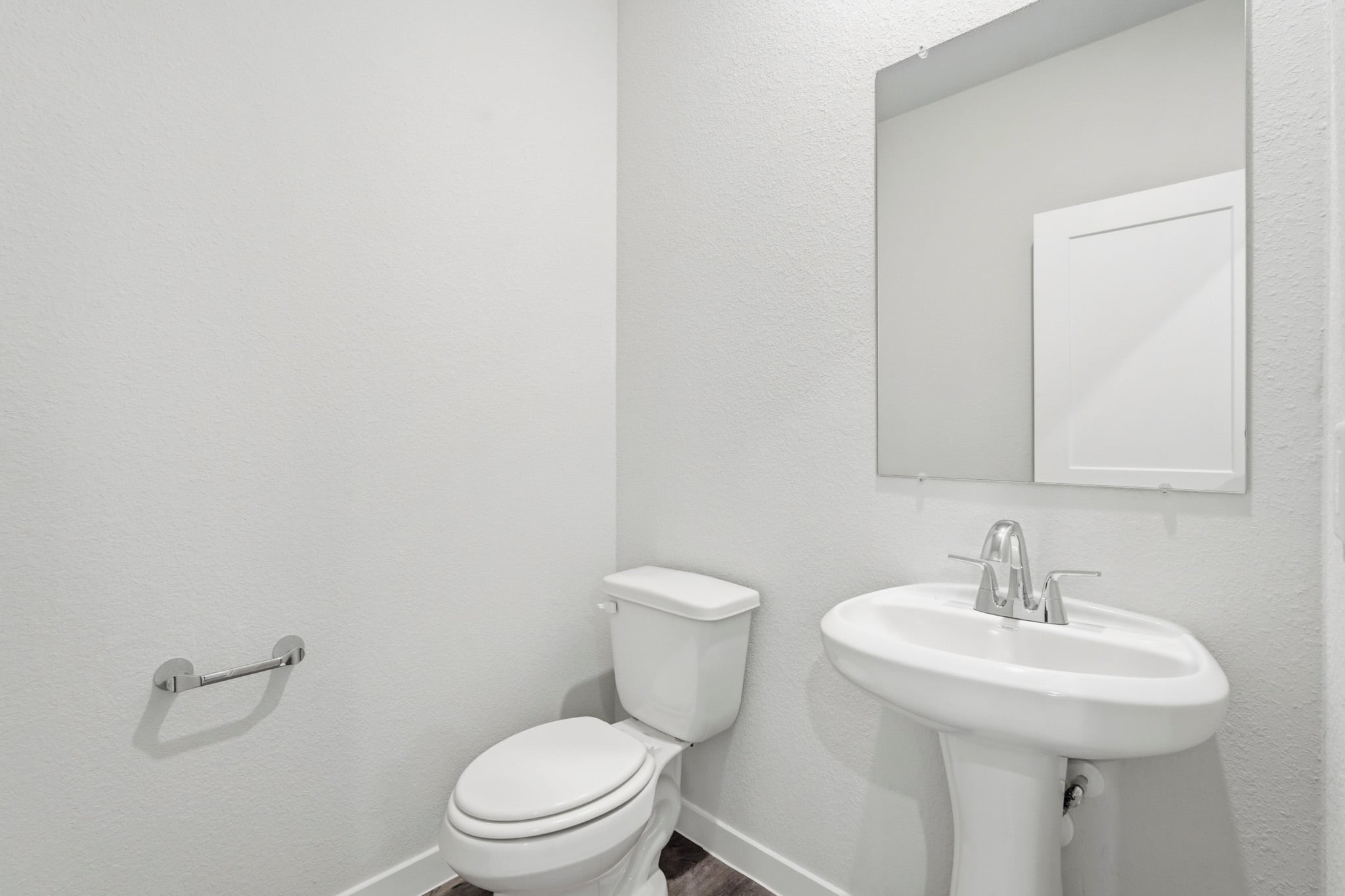 A bathroom with a toilet and sink.