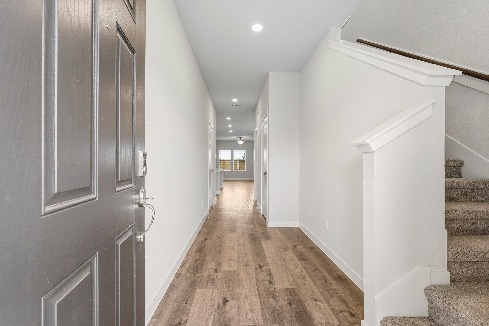 A hallway with white walls.