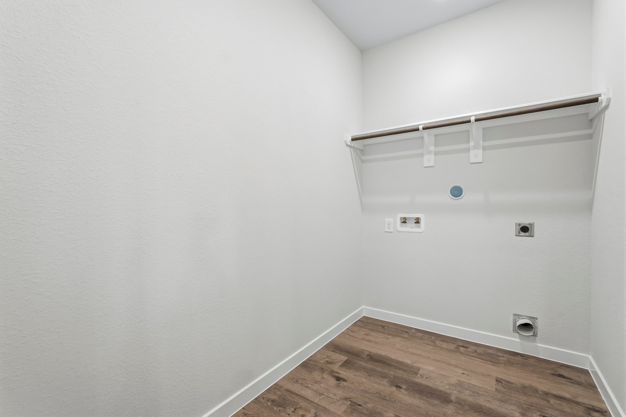 A white room with a wood floor.