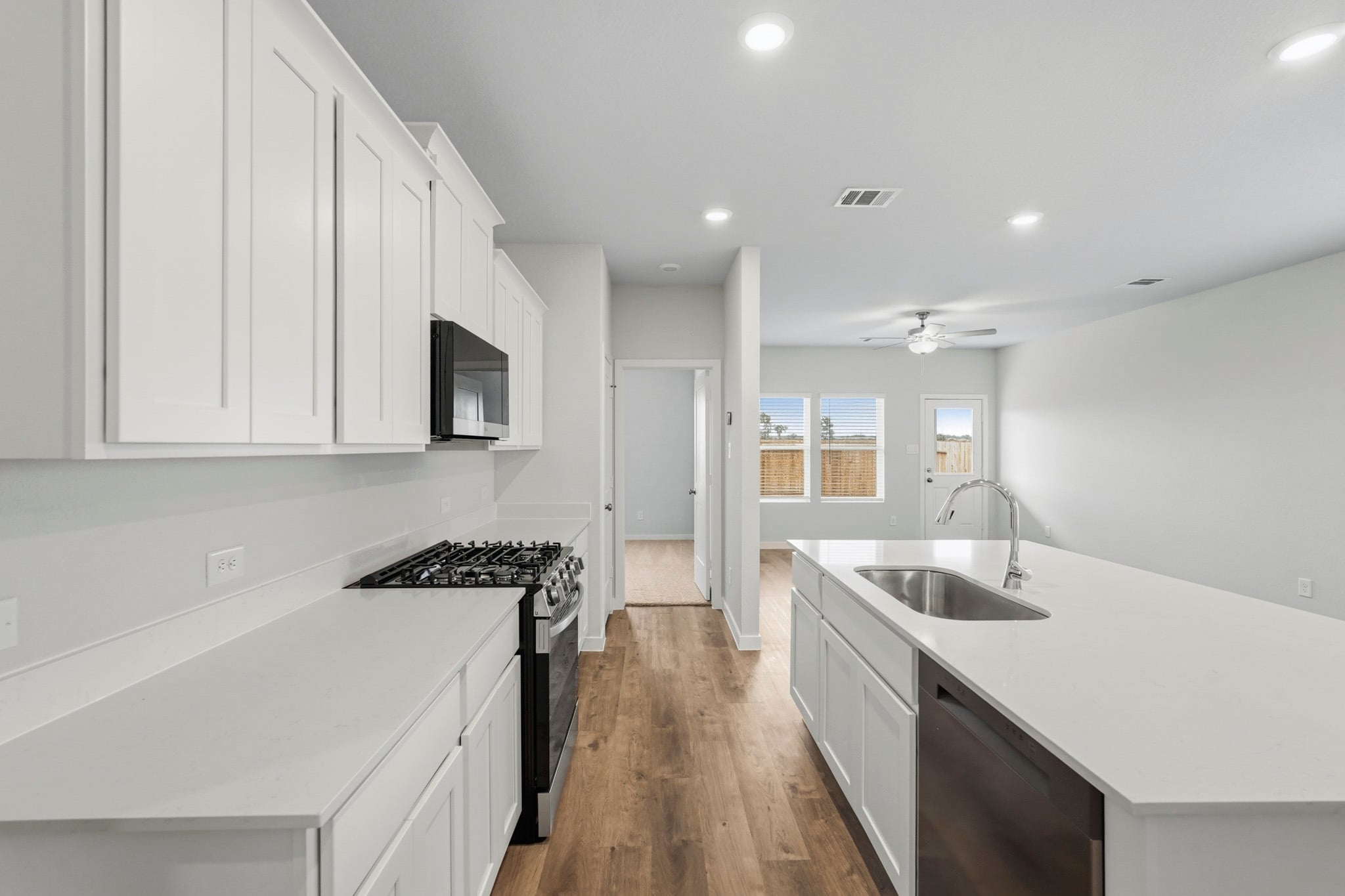 A kitchen with white cabinets.