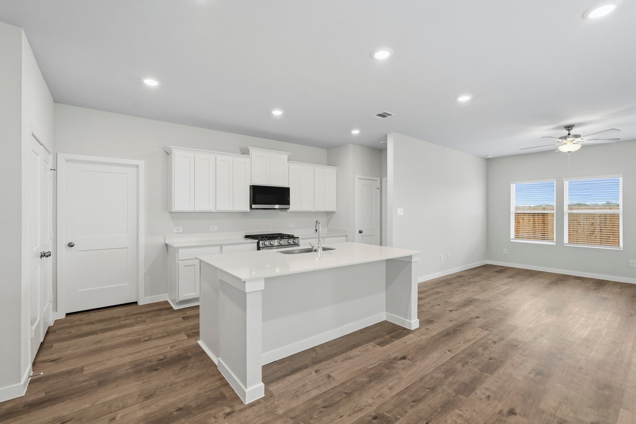 A kitchen with white cabinets.