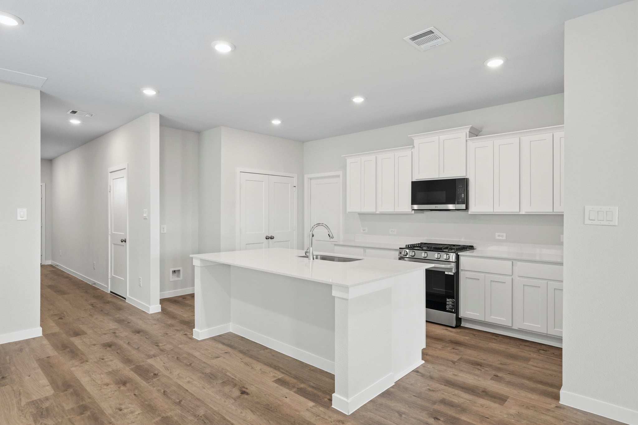 A kitchen with white cabinets.