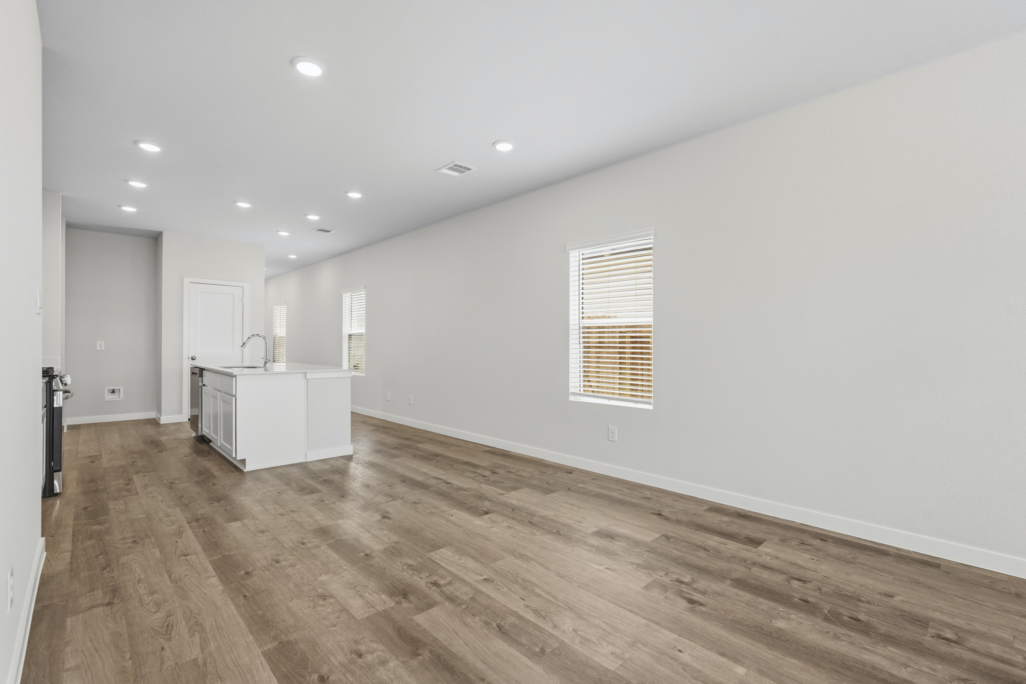 A room with white walls and wood floors.