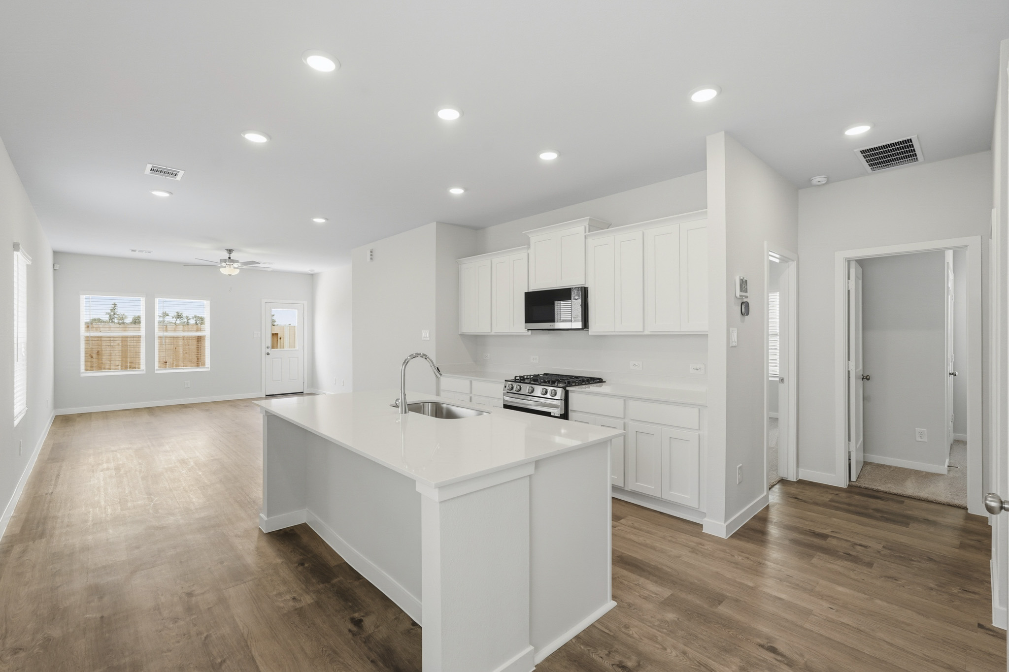 A kitchen with white cabinets.