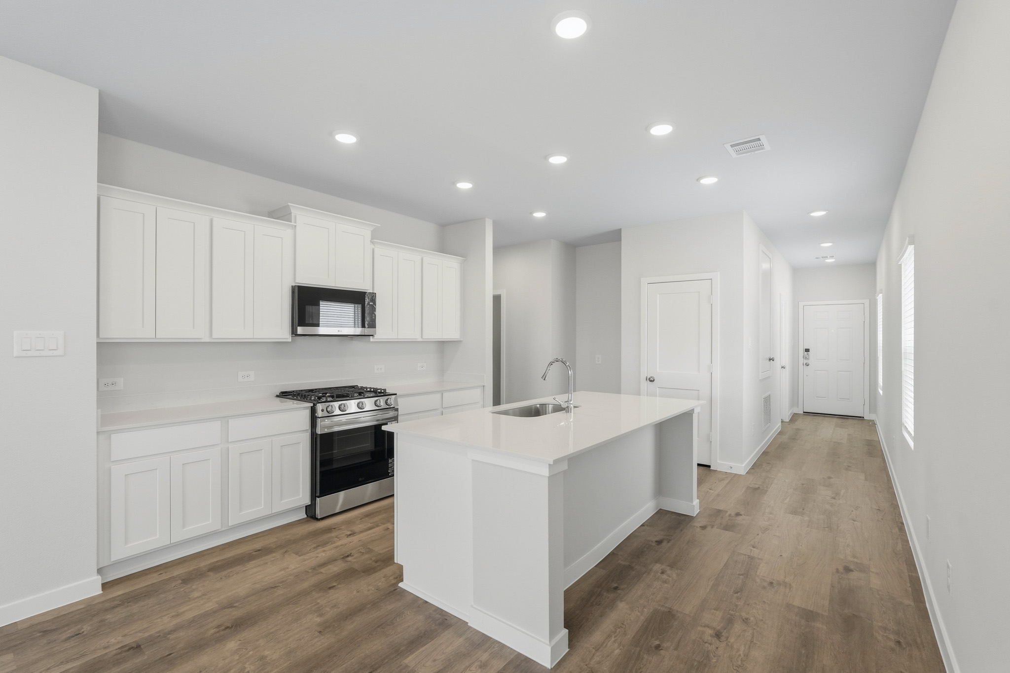 A kitchen with white cabinets.