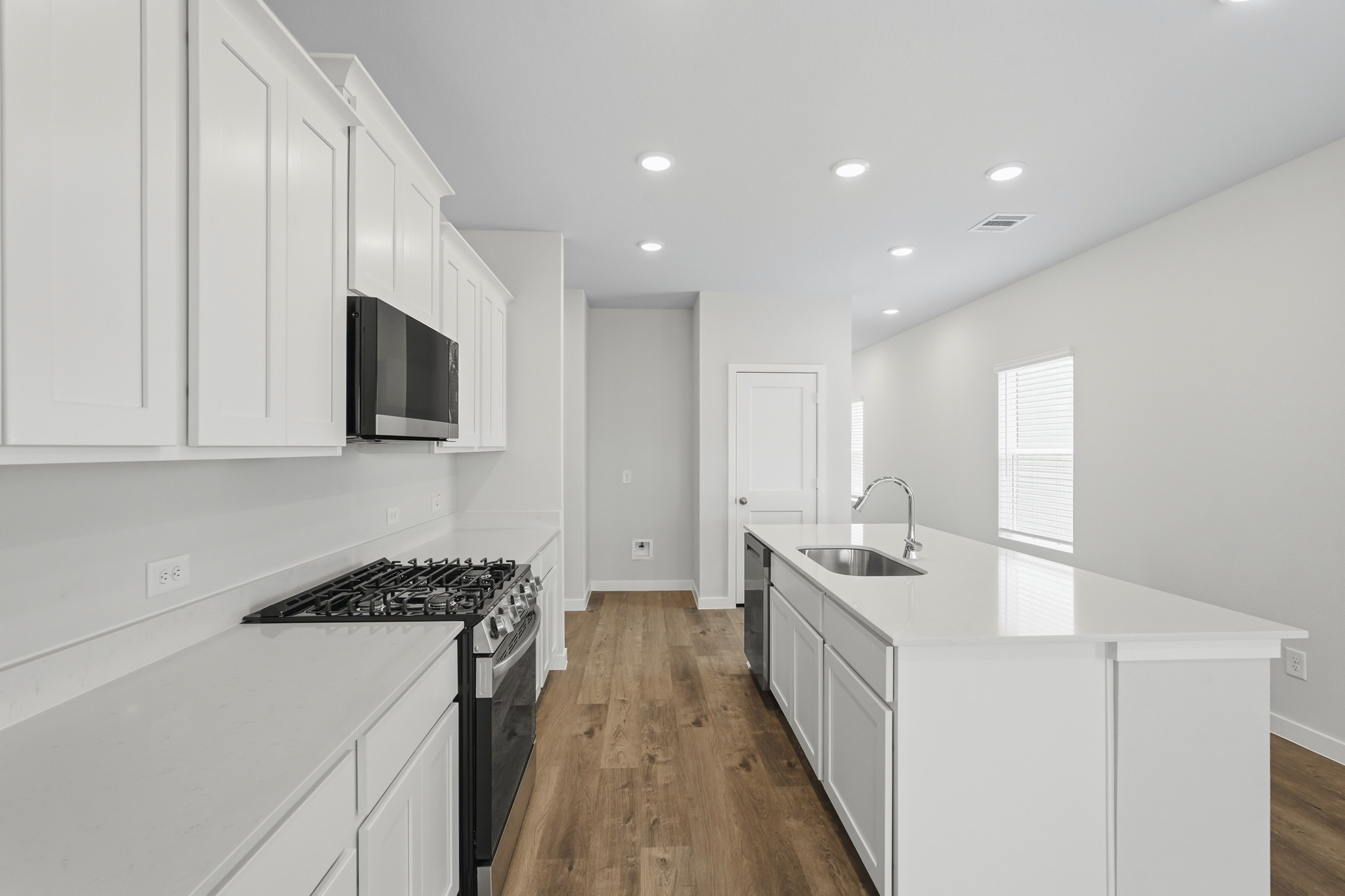 A kitchen with white cabinets.