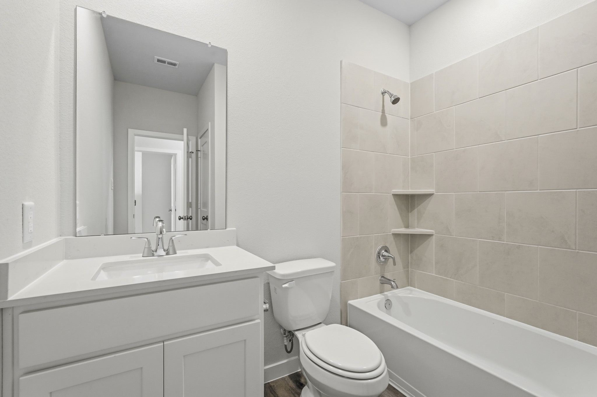 A bathroom with a tub sink and toilet.
