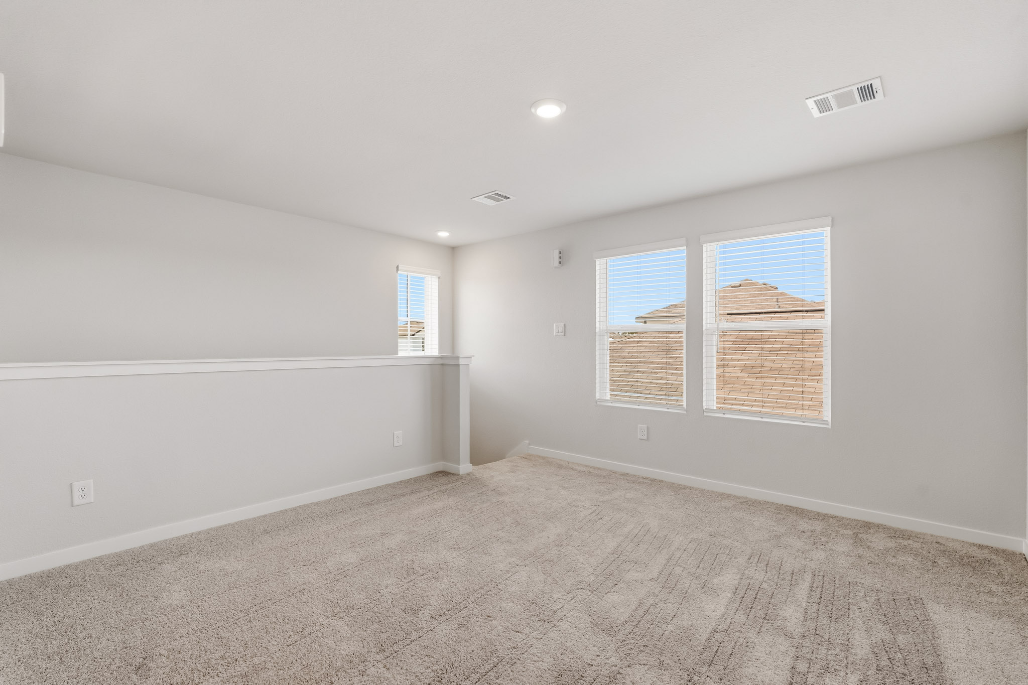 A room with a carpet and a window.