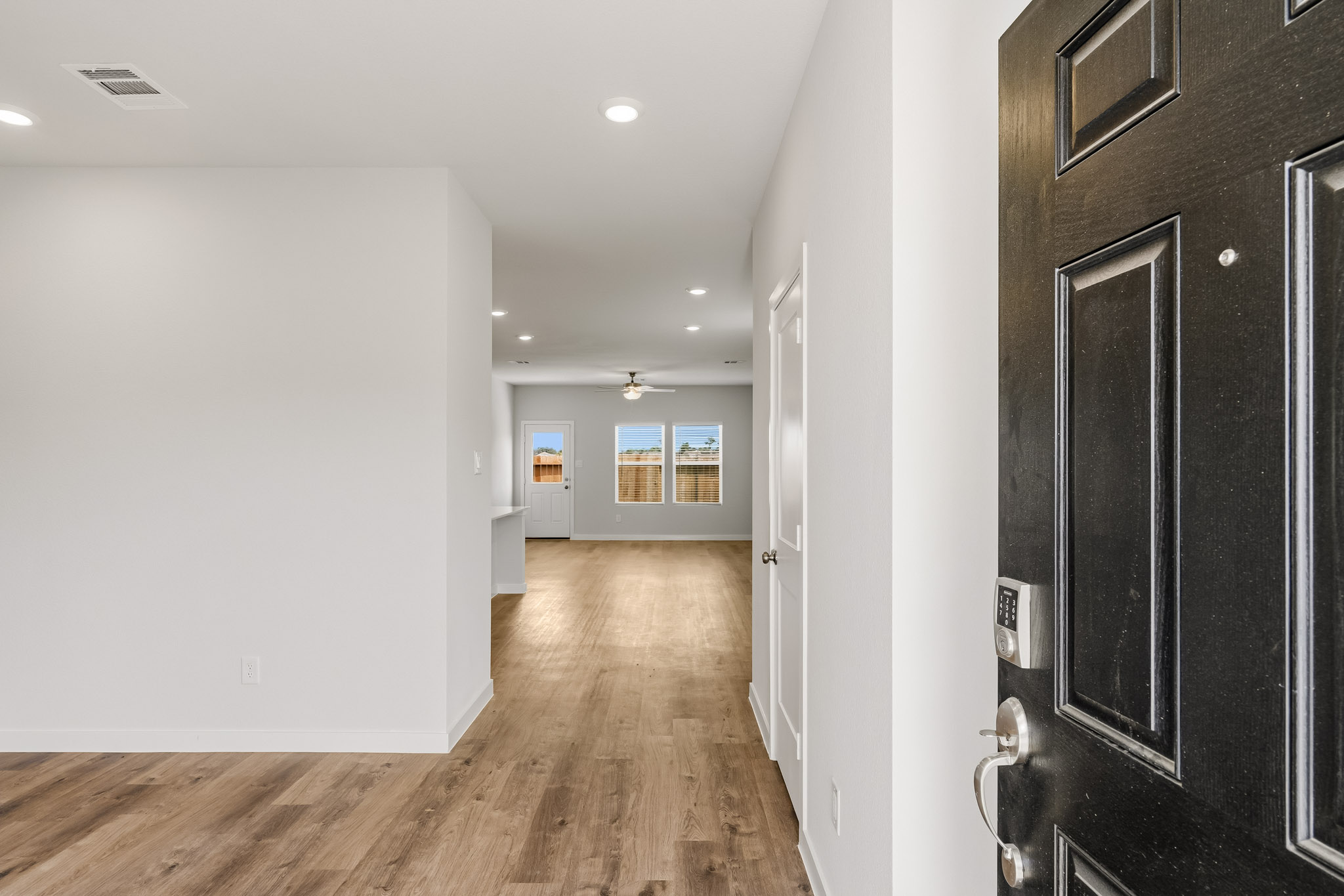 A hallway with black doors.