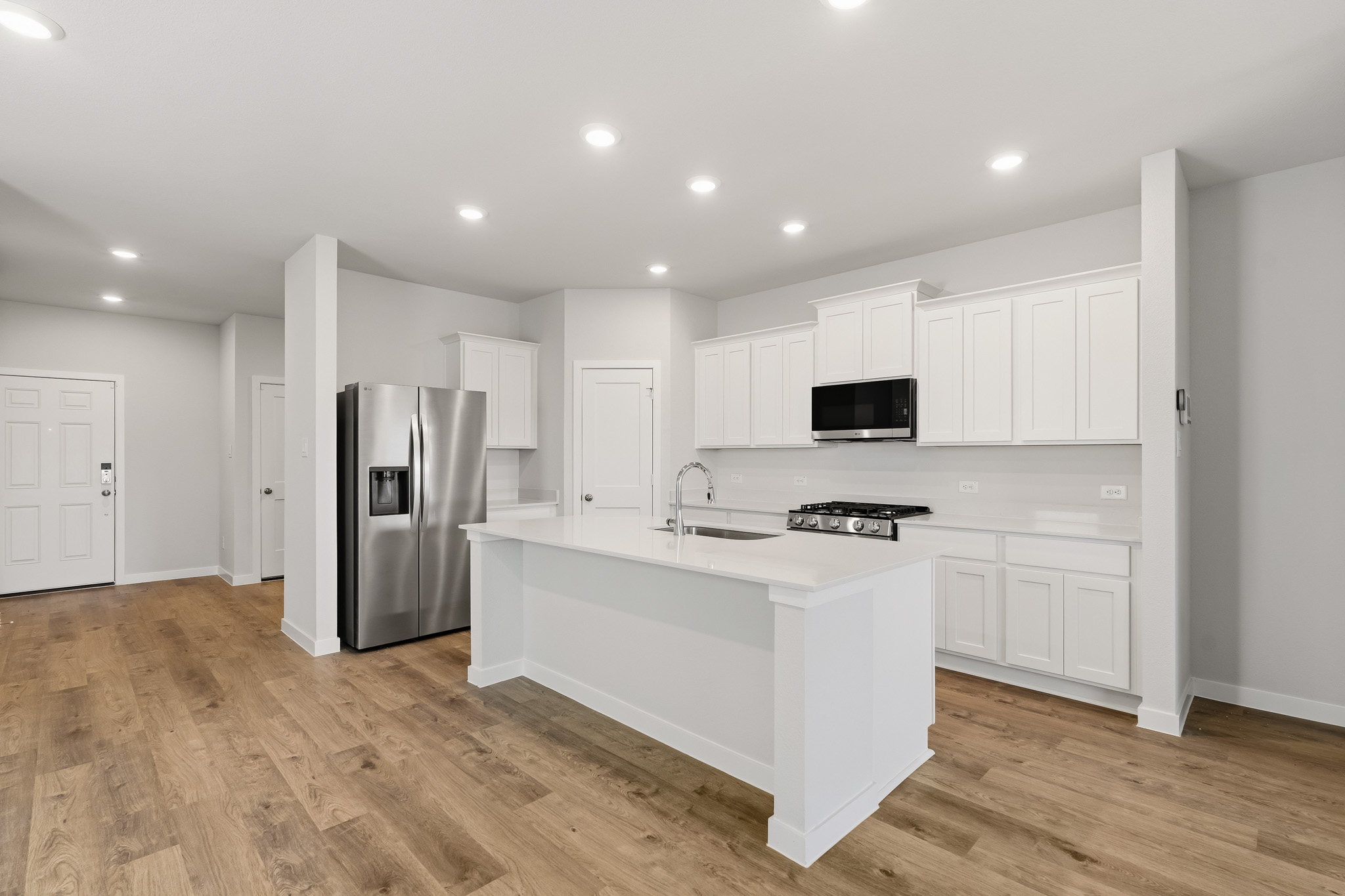 A kitchen with white cabinets.