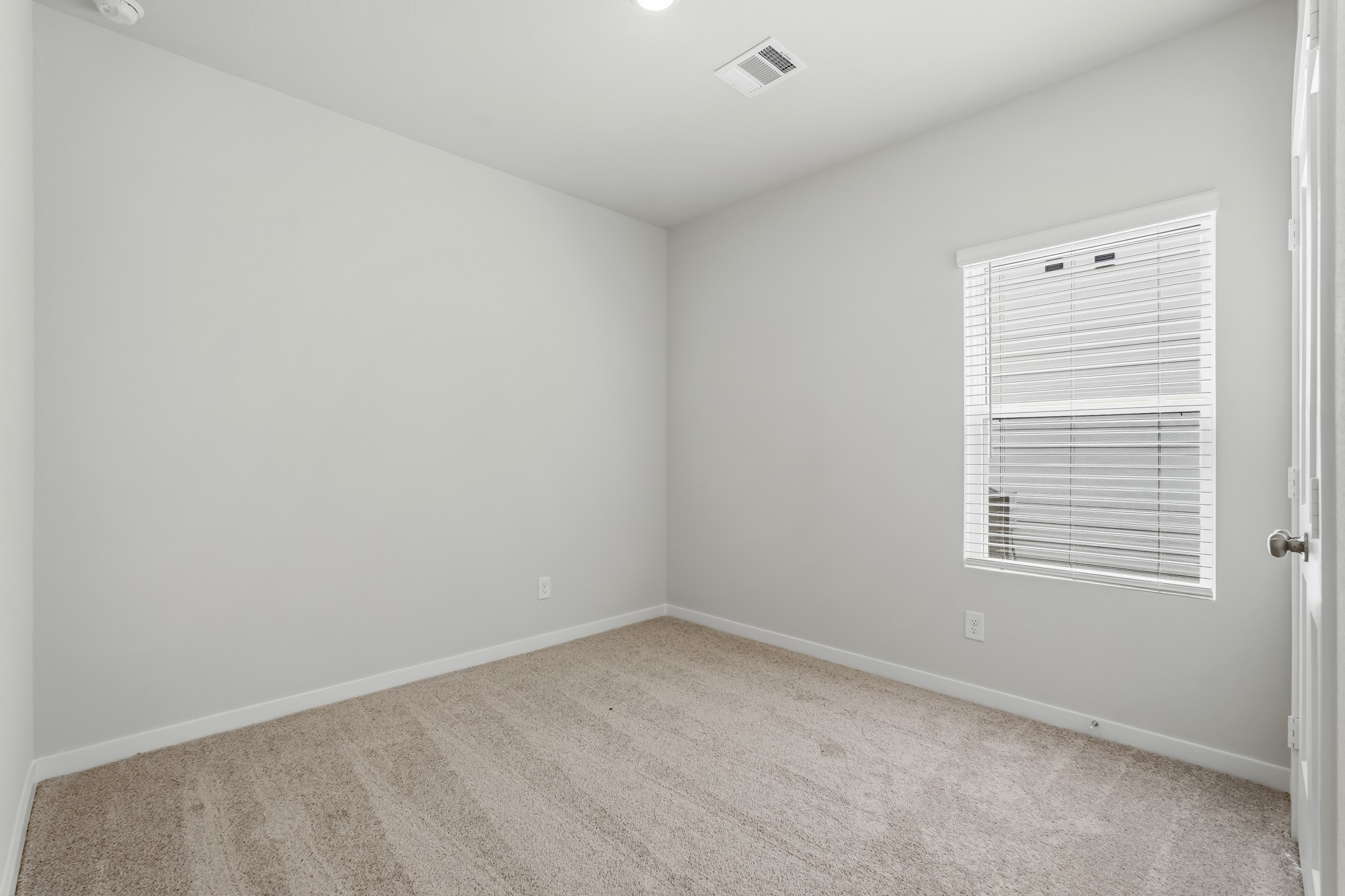A room with a door and a window.