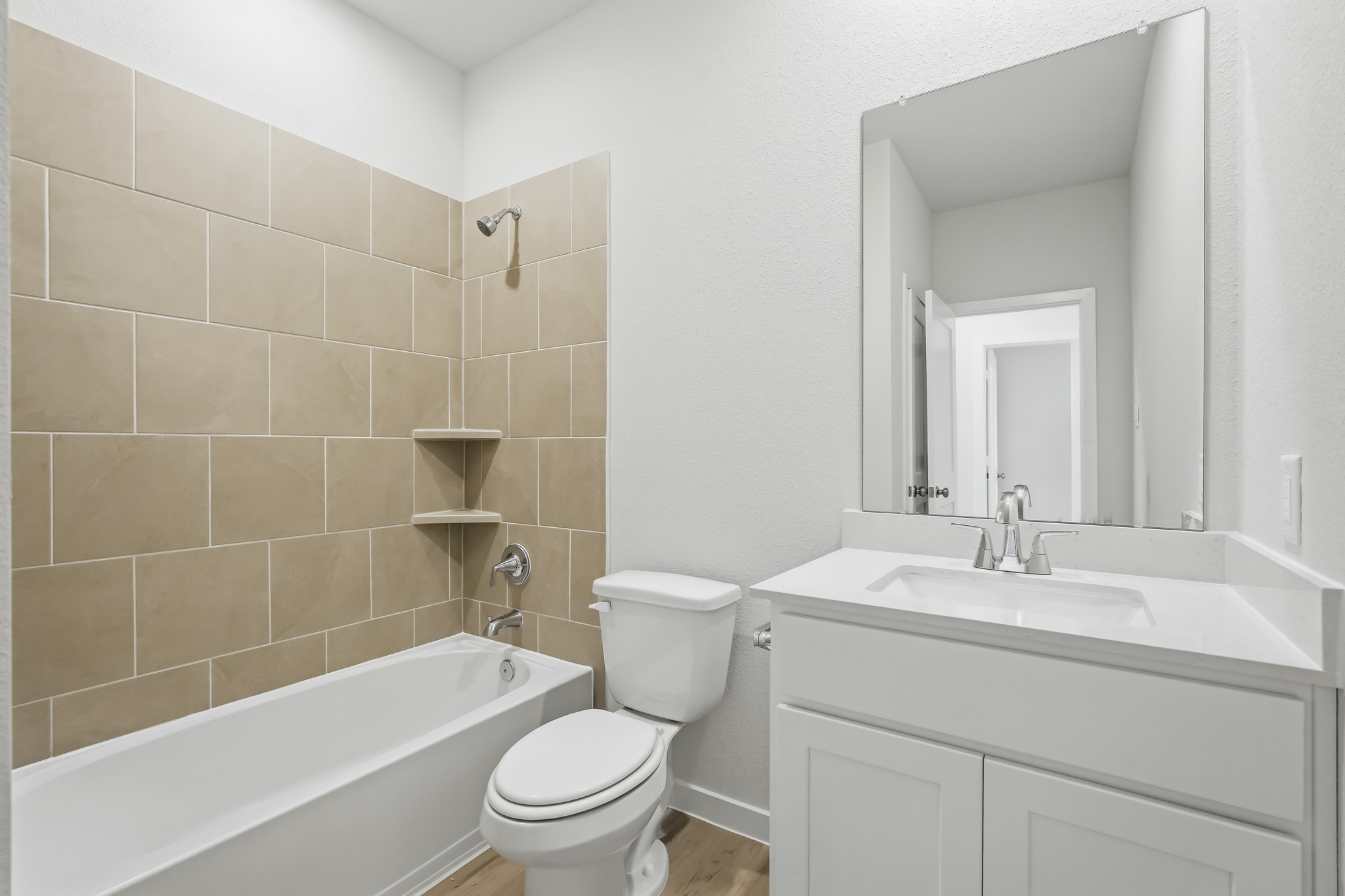 A bathroom with a tub sink and toilet.