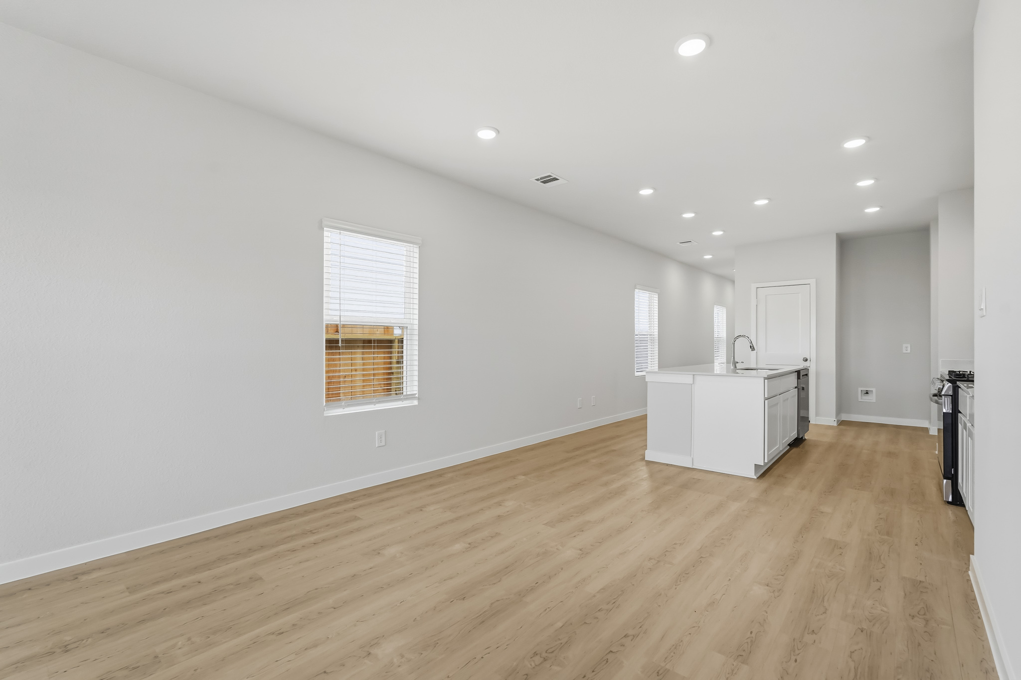 A room with white walls and wood floors.