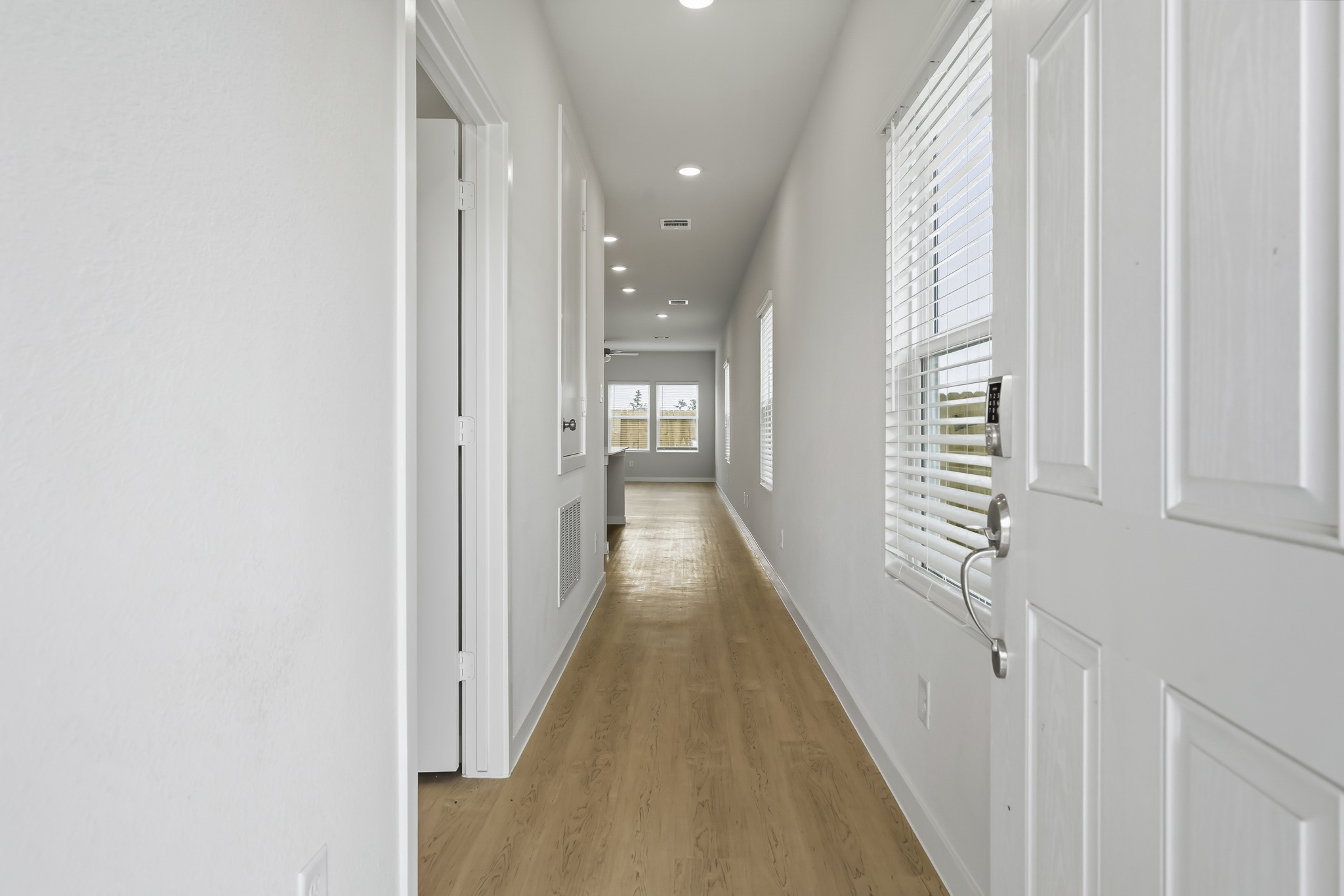 A hallway with white doors.