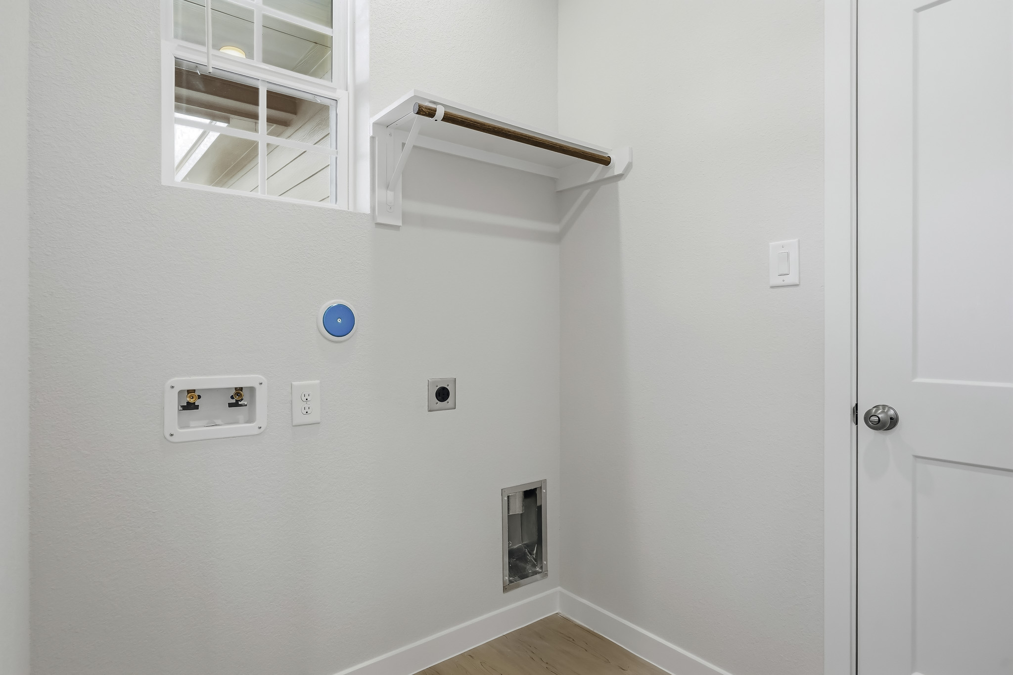 A white wall with a light on it.