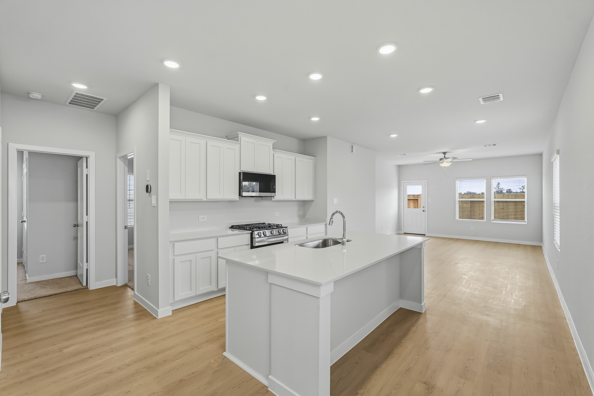 A kitchen with white cabinets.