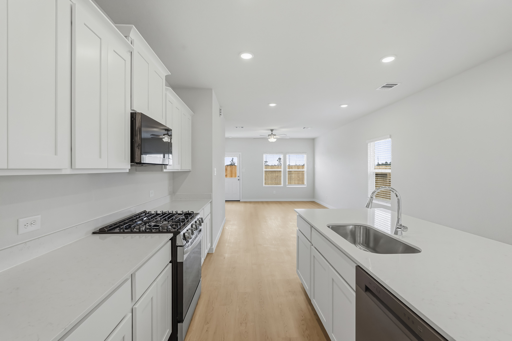A kitchen with white cabinets.