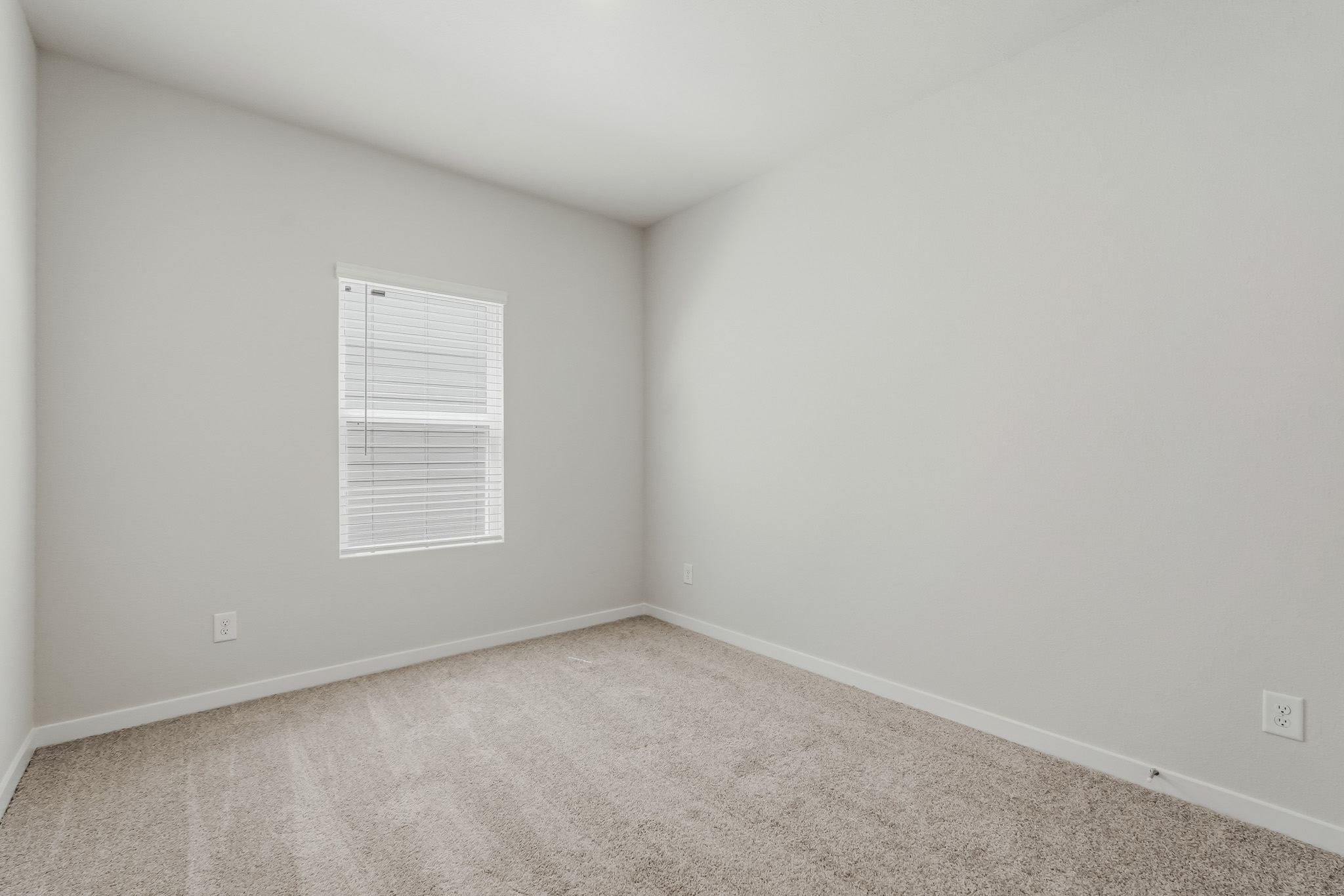 A white wall with a sign on it.