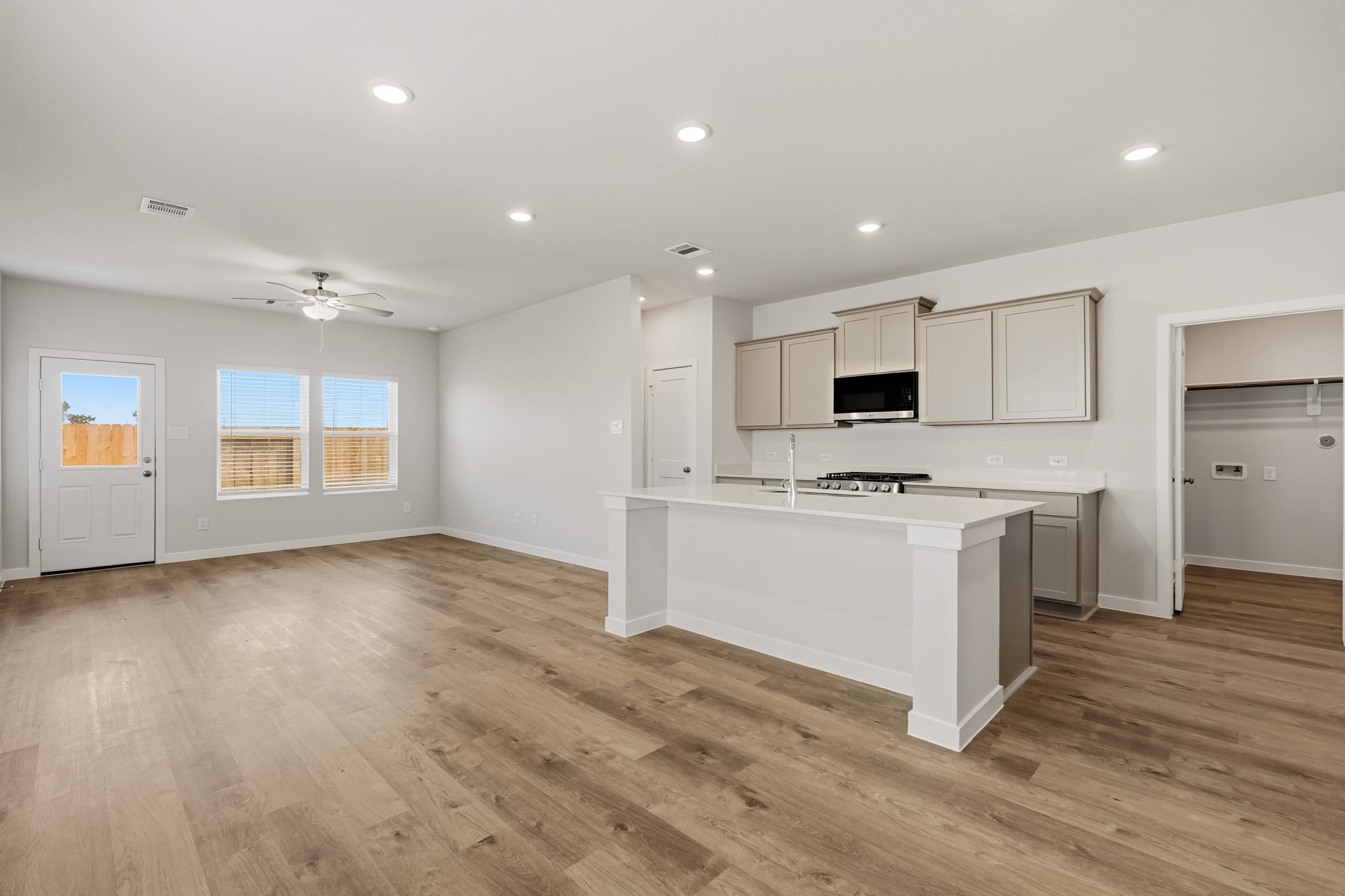 A kitchen with white cabinets.