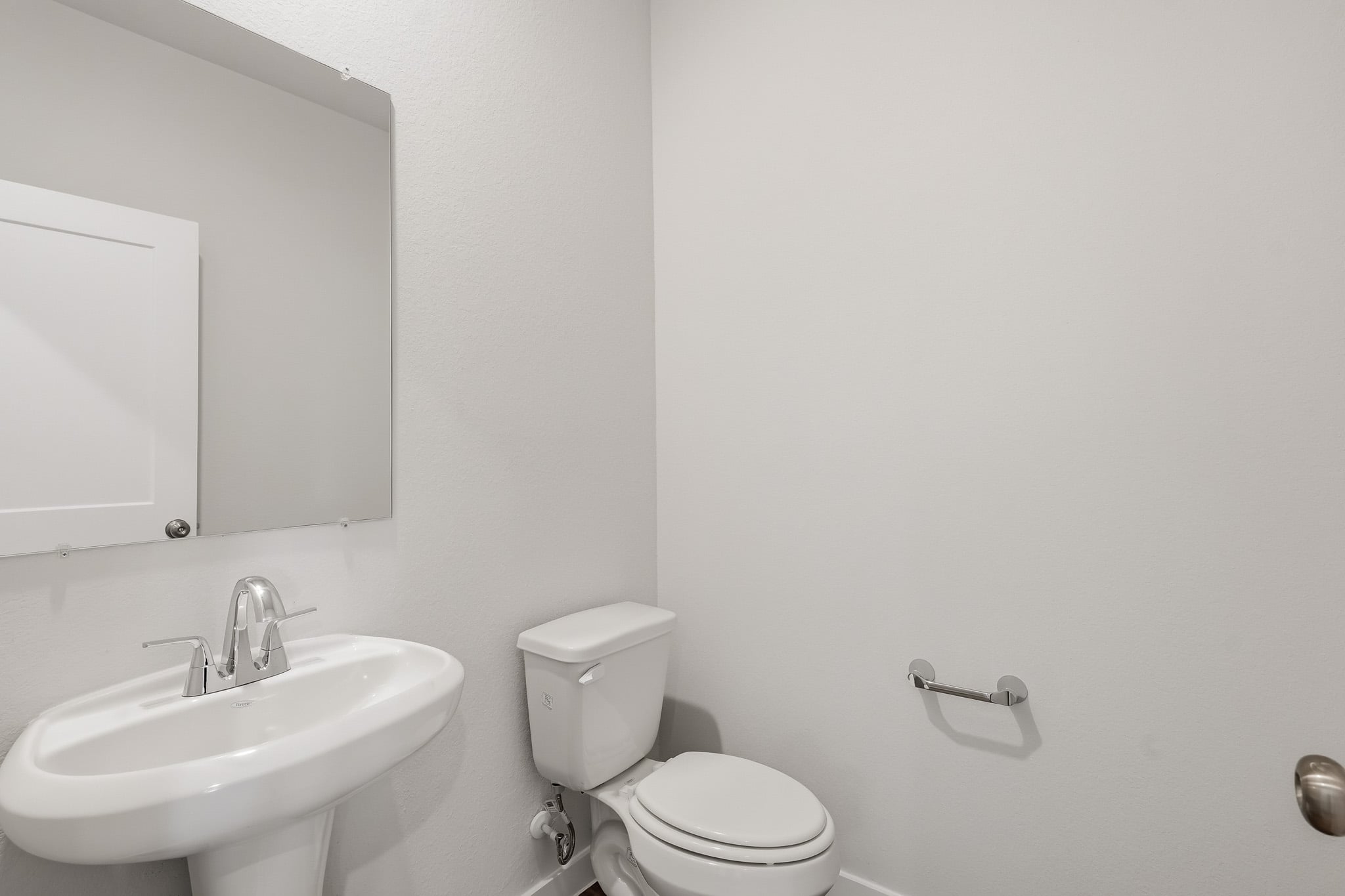 A bathroom with a toilet and sink.