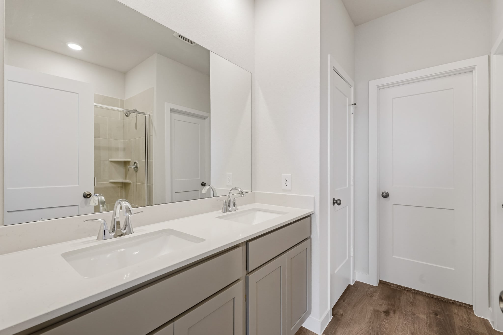 A bathroom with white cabinets.