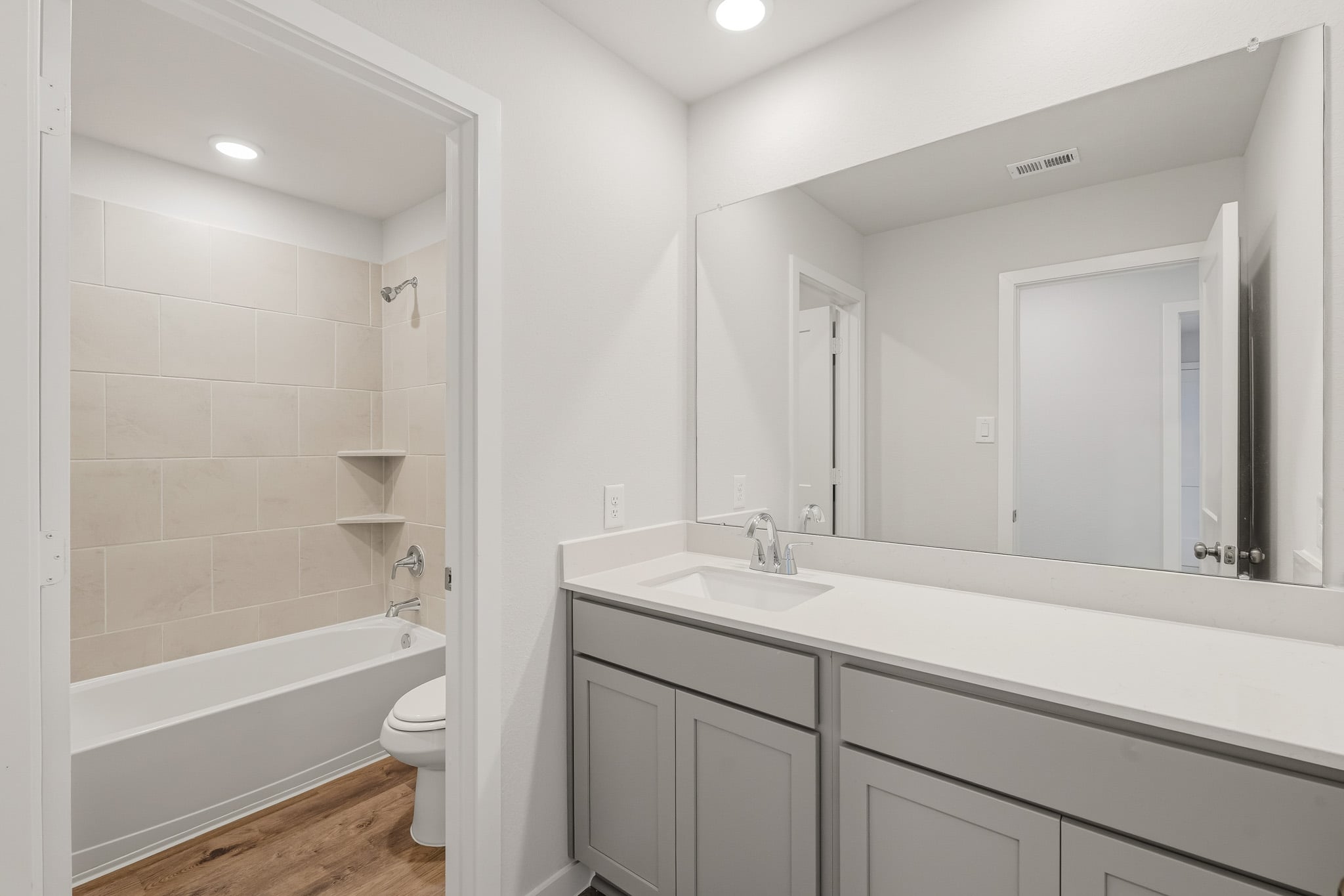 A bathroom with a tub sink and toilet.