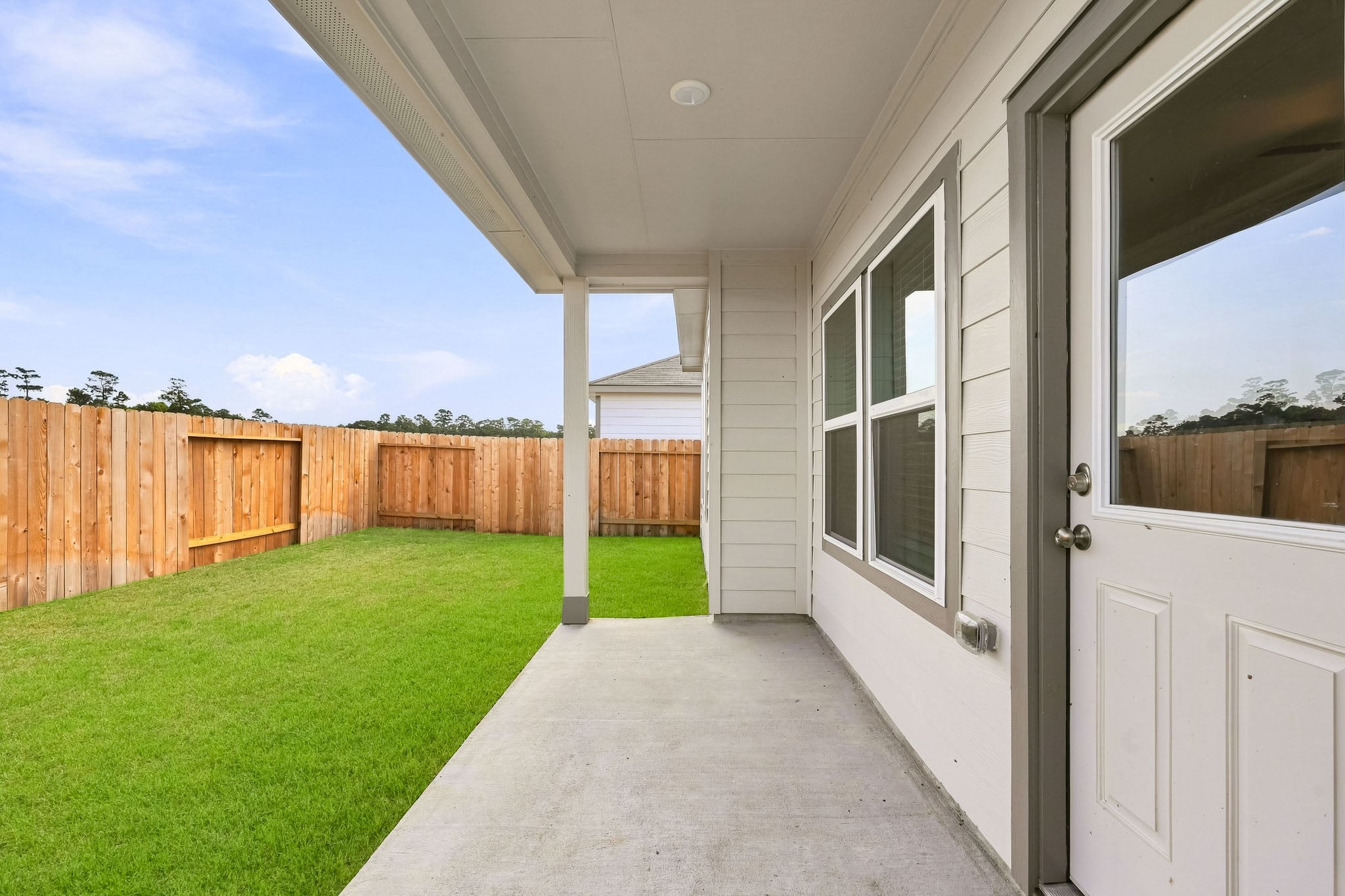 A house with a fence and grass.