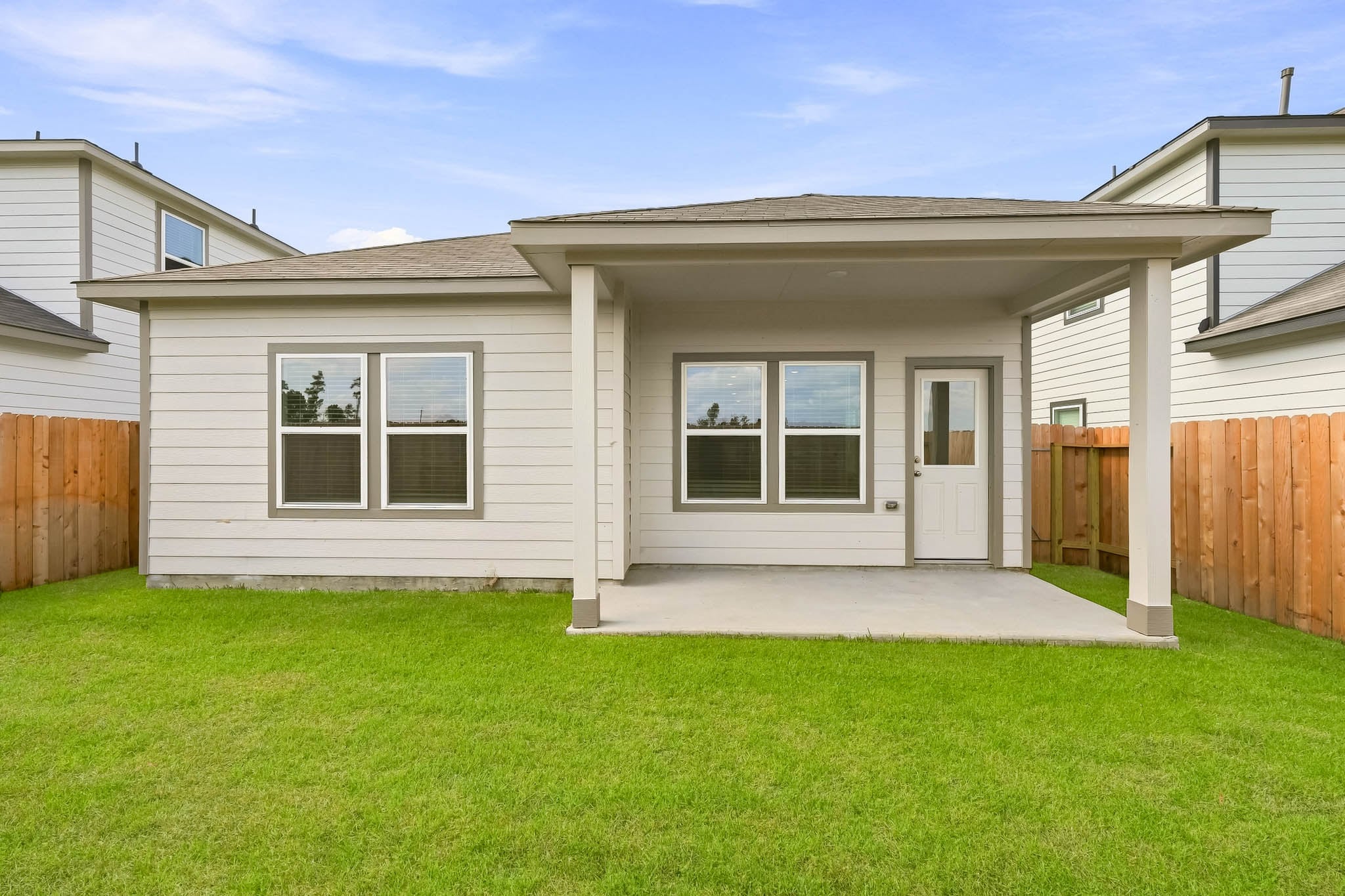 A house with a fence and grass.